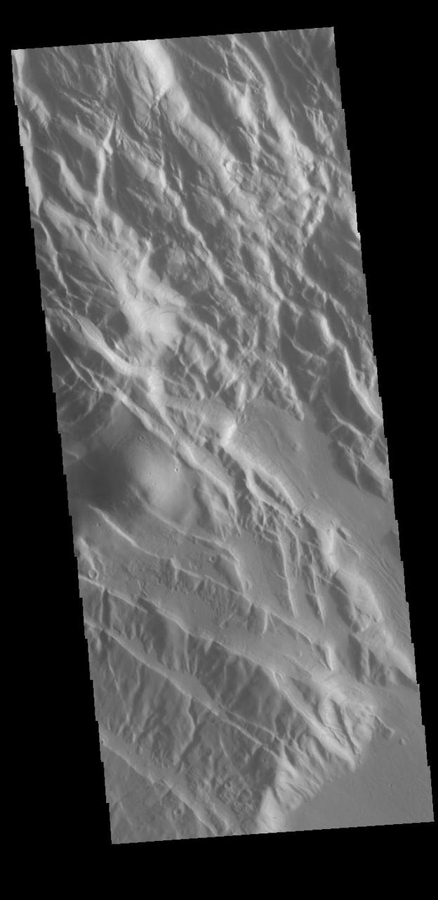 This VIS shows part of Acheron Fossae. Acheron Fossae is the highly fractured, faulted and deformed terrain located 1,050 kilometers (650 miles) north of the large shield volcano Olympus Mons. Lava flows from Olympus Mons at the base of Acheron Fossae show that the fossae predate the flows. The scarps visible in this image are approximately one kilometer (3,300 feet) high.  Orbit Number: 85794 Latitude: 36.0816 Longitude: 229.11 Instrument: VIS Captured: 2021-04-17 12:16  https://photojournal.jpl.nasa.gov/catalog/PIA24873