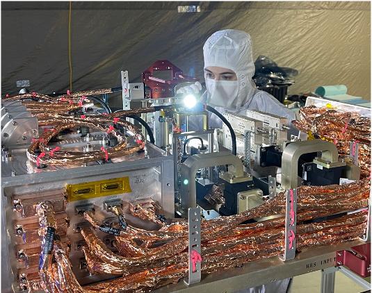 An engineer inspects the radio frequency (RF) panel of NASA's Europa Clipper in a cleanroom at the Johns Hopkins Applied Physics Laboratory in Laurel, Maryland. The RF panel hosts all the RF subsystem electronics and an intricate routing network of switches, filters, and waveguides, which carry the RF signal to and from eight antennas distributed around the spacecraft.  With an internal global ocean under a thick layer of ice, Jupiter's moon Europa may have the potential to harbor existing life. Europa Clipper will swoop around Jupiter in an elliptical orbit, dipping close to the moon on each flyby to collect data. Understanding Europa's habitability will help scientists better understand how life developed on Earth and the potential for finding life beyond our planet. Europa Clipper is set to launch in 2024.  https://photojournal.jpl.nasa.gov/catalog/PIA24898