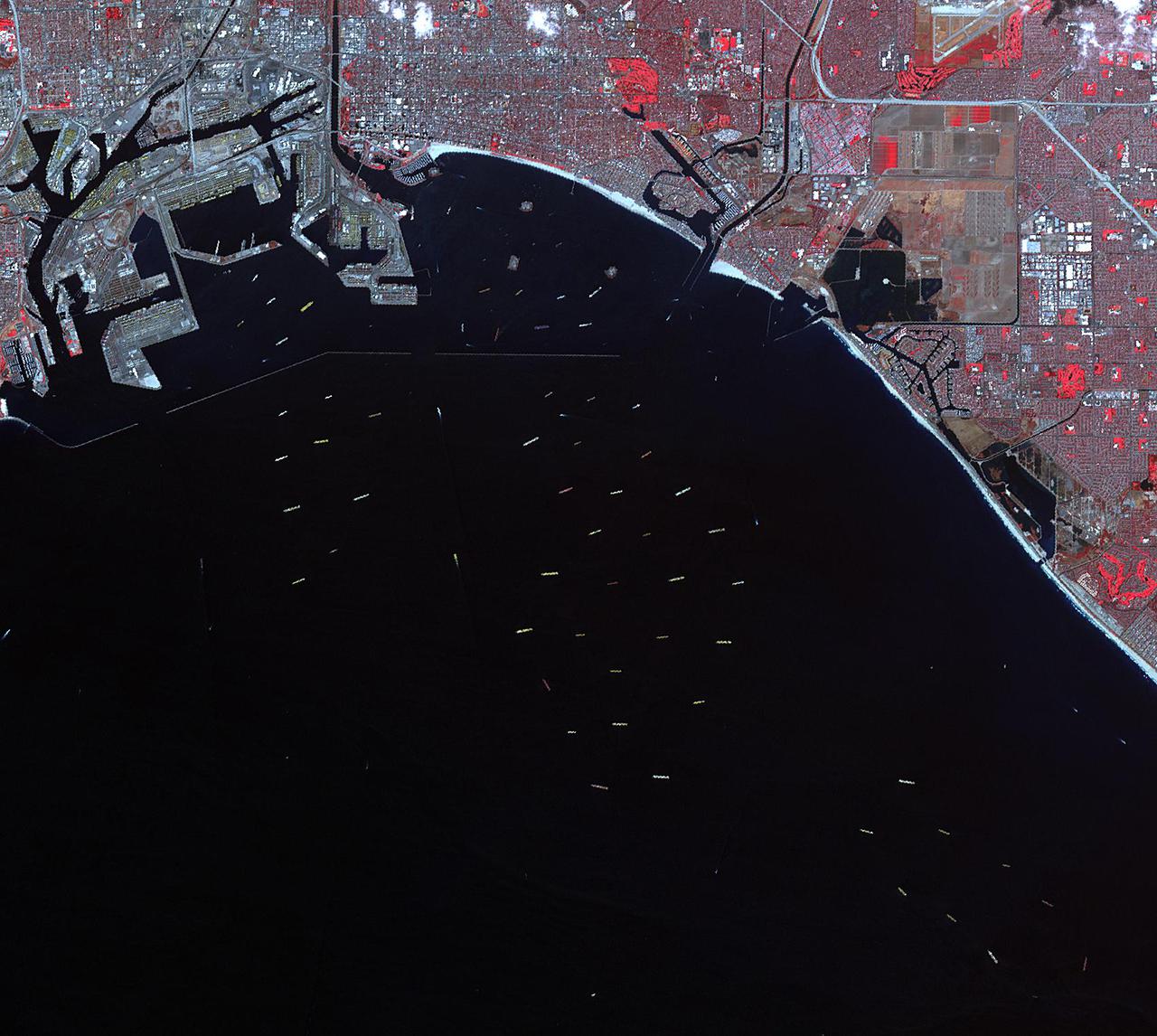 On Oct. 10, 2021, NASA's Advanced Spaceborne Thermal Emission and Reflection Radiometer (ASTER) instrument captured an image of over 70 ships waiting to dock and unload at the ports of Los Angeles and Long Beach, due to a supply-chain crunch. The image covers an area of 14 by 16 miles (23 by 25 kilometers).  https://photojournal.jpl.nasa.gov/catalog/PIA24902