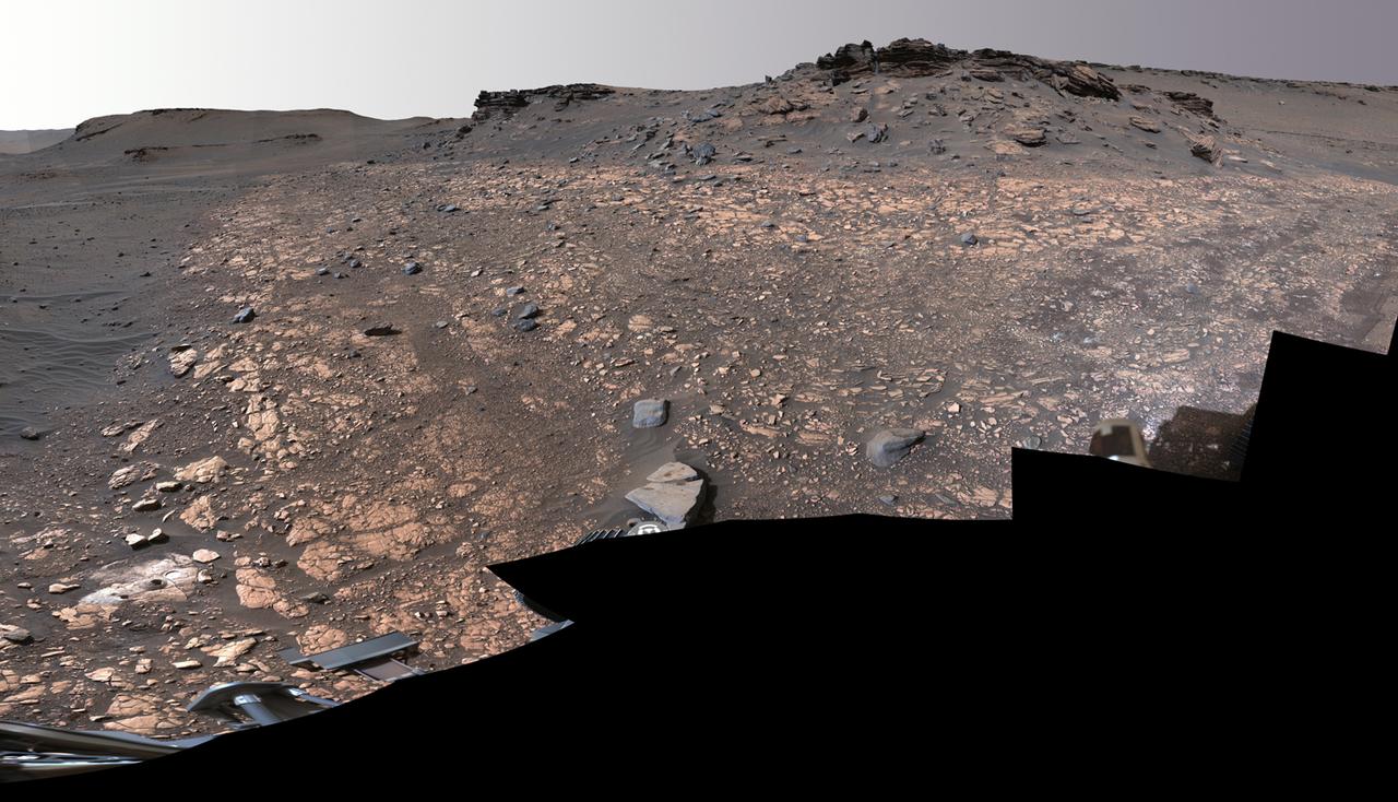 This image shows two locations in Mars's Jezero Crater where NASA's Perseverance rover collected rock samples for possible return to Earth in the future: "Wildcat Ridge" (lower left) and "Skinner Ridge" (upper right). These two outcrops are within about 70 feet (20 meters) of each other. The rover cored two cylinders of rock the size of classroom chalk (about 0.5 inches, or 13 millimeters, in diameter and 2.4 inches, or 60 millimeters, long) from each location.  The two sites are in the delta, a fan-shaped area where, billions of years ago, a river once flowed into a lake in Jezero Crater and deposited rocks and sediment. Scientists consider the sedimentary rocks preserved in the delta one of the best places on Mars to search for potential signs of ancient microbial life. The verification of ancient life on Mars carries an enormous burden of proof.  A light-colored, circular patch of abraded rock can be seen in the lower-left corner of the image, next to areas where Perseverance used its drill to extract the rock-core samples. The abrasion patch to the right of one of the holes is about 2 inches (5 centimeters) in diameter. The samples taken from these areas were sealed inside ultra-clean sample tubes, which are currently stored inside Perseverance.  The multiple images that make up this mosaic were acquired by Perseverance's Mastcam-Z instrument on Aug. 4, 2022, the 518st Martian day, or sol, of the rover's mission. The color bands of the image have been processed to improve visual contrast and accentuate color differences.  A key objective for Perseverance's mission on Mars is astrobiology, including the search for signs of ancient microbial life. The rover will characterize the planet's geology and past climate, pave the way for human exploration of the Red Planet, and be the first mission to collect and cache Martian rock and regolith (broken rock and dust).  Subsequent NASA missions, in cooperation with ESA (European Space Agency), would send spacecraft to Mars to collect these sealed samples from the surface and return them to Earth for in-depth analysis.  The Mars 2020 Perseverance mission is part of NASA's Moon to Mars exploration approach, which includes Artemis missions to the Moon that will help prepare for human exploration of the Red Planet.  https://photojournal.jpl.nasa.gov/catalog/PIA24924