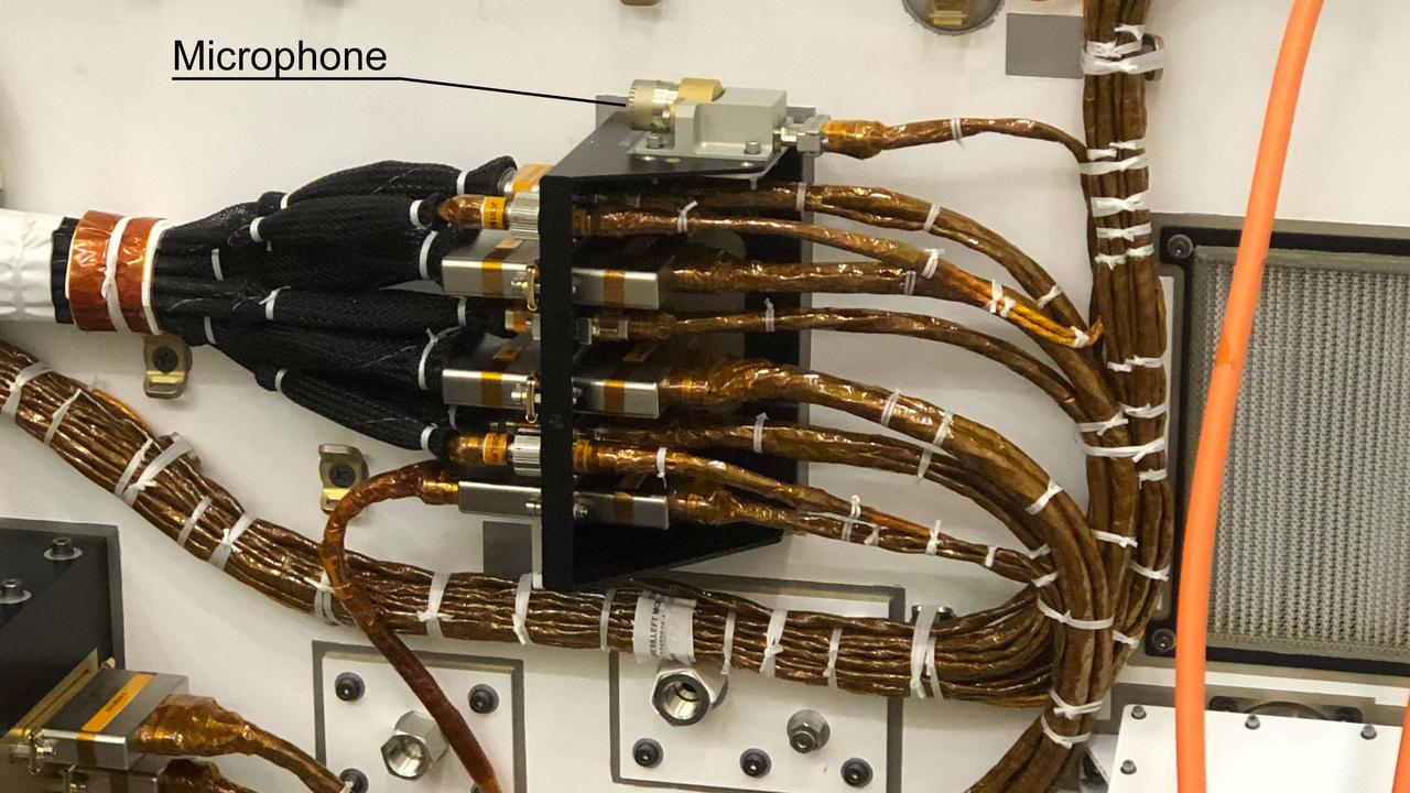 NASA's Perseverance Mars rover carries two commercial-grade microphones, including this one on its chassis. It was provided to record the sound of entry, descent and landing, though a software glitch prevented it from doing so. A second microphone, part of the SuperCam instrument, is included on the rover's mast. The mast microphone was included for specific science objectives.  A key objective for Perseverance's mission on Mars is astrobiology, including the search for signs of ancient microbial life. The rover will characterize the planet's geology and past climate, pave the way for human exploration of the Red Planet, and be the first mission to collect and cache Martian rock and regolith (broken rock and dust).  Subsequent NASA missions, in cooperation with ESA (European Space Agency), would send spacecraft to Mars to collect these sealed samples from the surface and return them to Earth for in-depth analysis.  The Mars 2020 Perseverance mission is part of NASA's Moon to Mars exploration approach, which includes Artemis missions to the Moon that will help prepare for human exploration of the Red Planet.  https://photojournal.jpl.nasa.gov/catalog/PIA24933
