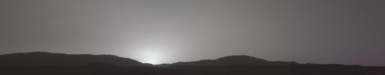 This sunset on Mars was captured by NASA's Perseverance Mars rover using its Mastcam-Z camera system on Nov. 9, 2021, the 257th Martian day, or sol, of the mission.  Martian sunsets typically stand out for their distinctive blue color. Fine dust in the atmosphere permits blue light to penetrate the atmosphere more efficiently than colors with longer wavelengths. But this sunset looks different: less dust in the atmosphere resulted in a more muted color than average. The color has been calibrated and white-balanced to remove camera artifacts.  The Mastcam-Z investigation is led and operated by Arizona State University in Tempe, working in collaboration with Malin Space Science Systems in San Diego, California, on the design, fabrication, testing, and operation of the cameras, and in collaboration with the Neils Bohr Institute of the University of Copenhagen on the design, fabrication, and testing of the calibration targets.  A key objective for Perseverance's mission on Mars is astrobiology, including the search for signs of ancient microbial life. The rover will characterize the planet's geology and past climate, pave the way for human exploration of the Red Planet, and be the first mission to collect and cache Martian rock and regolith (broken rock and dust).  Subsequent NASA missions, in cooperation with ESA (European Space Agency), would send spacecraft to Mars to collect these sealed samples from the surface and return them to Earth for in-depth analysis.  The Mars 2020 Perseverance mission is part of NASA's Moon to Mars exploration approach, which includes Artemis missions to the Moon that will help prepare for human exploration of the Red Planet.  https://photojournal.jpl.nasa.gov/catalog/PIA24935
