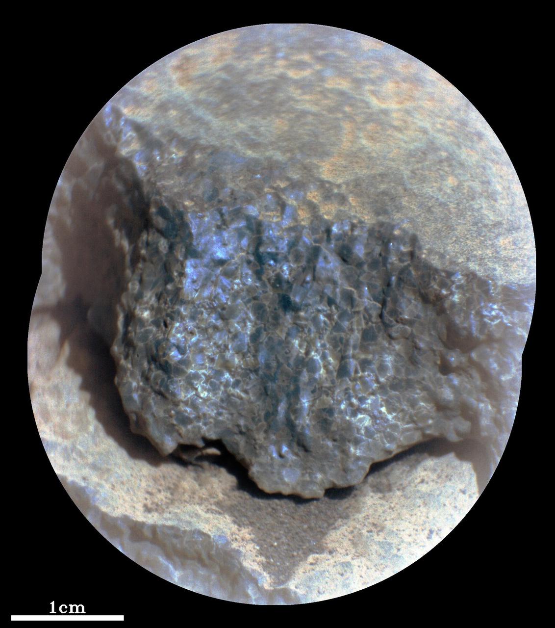 This enhanced-color close-up of a rock target called "Cine" was captured by the SuperCam instrument aboard NASA's Perseverance Mars rover on Sept. 17, 2021, the 206th Martian day, or sol, of rover's mission. SuperCam’s Remote Microscopic Imager took two images that were later combined to form this close-up. The target is 92 inches (2 meters) away, seen from the rover's mast.  The image shows a rock layer made up of tightly packed millimeter-size gray, angular grains, or crystals. The image on the right shows a detail of the grain/crystal texture. The composition of this rock target was investigated with SuperCam's laser and spectrometer, along with the Mastcam-Z camera. Using these instruments, scientists can study the chemical composition of rocks from a distance. Analysis of "Cine" showed that it is rich in the mineral olivine. After the image was taken, the mission’s science team debated whether the rock is igneous (volcanic) or consists of fine sedimentary grains of igneous material that were cemented together in a watery environment.  SuperCam is led by Los Alamos National Laboratory in New Mexico, where the instrument's body unit was developed. That part of the instrument includes several spectrometers as well as control electronics and software. The mast unit, including the Remote Microscopic Imager used for these images, was developed and built by several laboratories of the CNRS (the French research center) and French universities under the contracting authority of Centre National d'Etudes Spatiales (CNES), the French space agency.  A key objective for Perseverance's mission on Mars is astrobiology, including the search for signs of ancient microbial life. The rover will characterize the planet's geology and past climate, pave the way for human exploration of the Red Planet, and be the first mission to collect and cache Martian rock and regolith (broken rock and dust).  Subsequent NASA missions, in cooperation with ESA (European Space Agency), would send spacecraft to Mars to collect these sealed samples from the surface and return them to Earth for in-depth analysis.  The Mars 2020 Perseverance mission is part of NASA's Moon to Mars exploration approach, which includes Artemis missions to the Moon that will help prepare for human exploration of the Red Planet.  https://photojournal.jpl.nasa.gov/catalog/PIA24936
