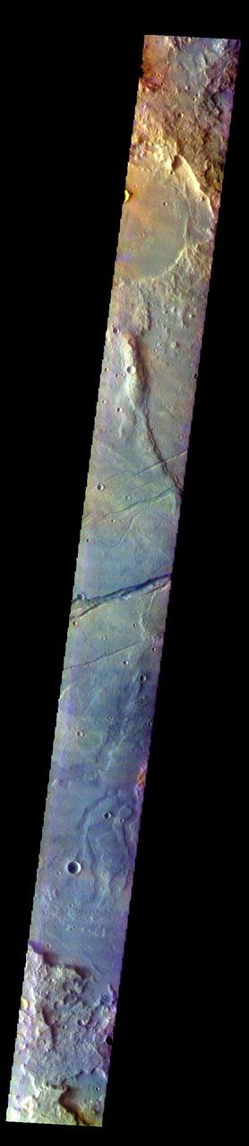 The THEMIS VIS camera contains 5 filters. The data from different filters can be combined in multiple ways to create a false color image. These false color images may reveal subtle variations of the surface not easily identified in a single band image. Today's false color image shows part of Sirenum Fossae. The linear depressions in this VIS image are tectonic graben. Graben are formed by extension of the crust and faulting. When large amounts of pressure or tension are applied to rocks on timescales that are fast enough that the rock cannot respond by deforming, the rock breaks along faults. In the case of a graben, two parallel faults are formed by extension of the crust and the rock in between the faults drops downward into the space created by the extension. Several graben are visible in this THEMIS VIS image, trending from north-northeast to south-southwest. Because the faults defining the graben are formed parallel to the direction of the applied stress, we know that extensional forces were pulling the crust apart in the west-northwest/east-southeast direction. The Sirenum Fossae graben are 2735km (1700 miles) long.  The THEMIS VIS camera is capable of capturing color images of the Martian surface using five different color filters. In this mode of operation, the spatial resolution and coverage of the image must be reduced to accommodate the additional data volume produced from using multiple filters. To make a color image, three of the five filter images (each in grayscale) are selected. Each is contrast enhanced and then converted to a red, green, or blue intensity image. These three images are then combined to produce a full color, single image. Because the THEMIS color filters don't span the full range of colors seen by the human eye, a color THEMIS image does not represent true color. Also, because each single-filter image is contrast enhanced before inclusion in the three-color image, the apparent color variation of the scene is exaggerated. Nevertheless, the color variation that does appear is representative of some change in color, however subtle, in the actual scene. Note that the long edges of THEMIS color images typically contain color artifacts that do not represent surface variation.  Orbit Number: 84379 Latitude: -32.7134 Longitude: 204.562 Instrument: VIS Captured: 2020-12-22 01:06  https://photojournal.jpl.nasa.gov/catalog/PIA25004