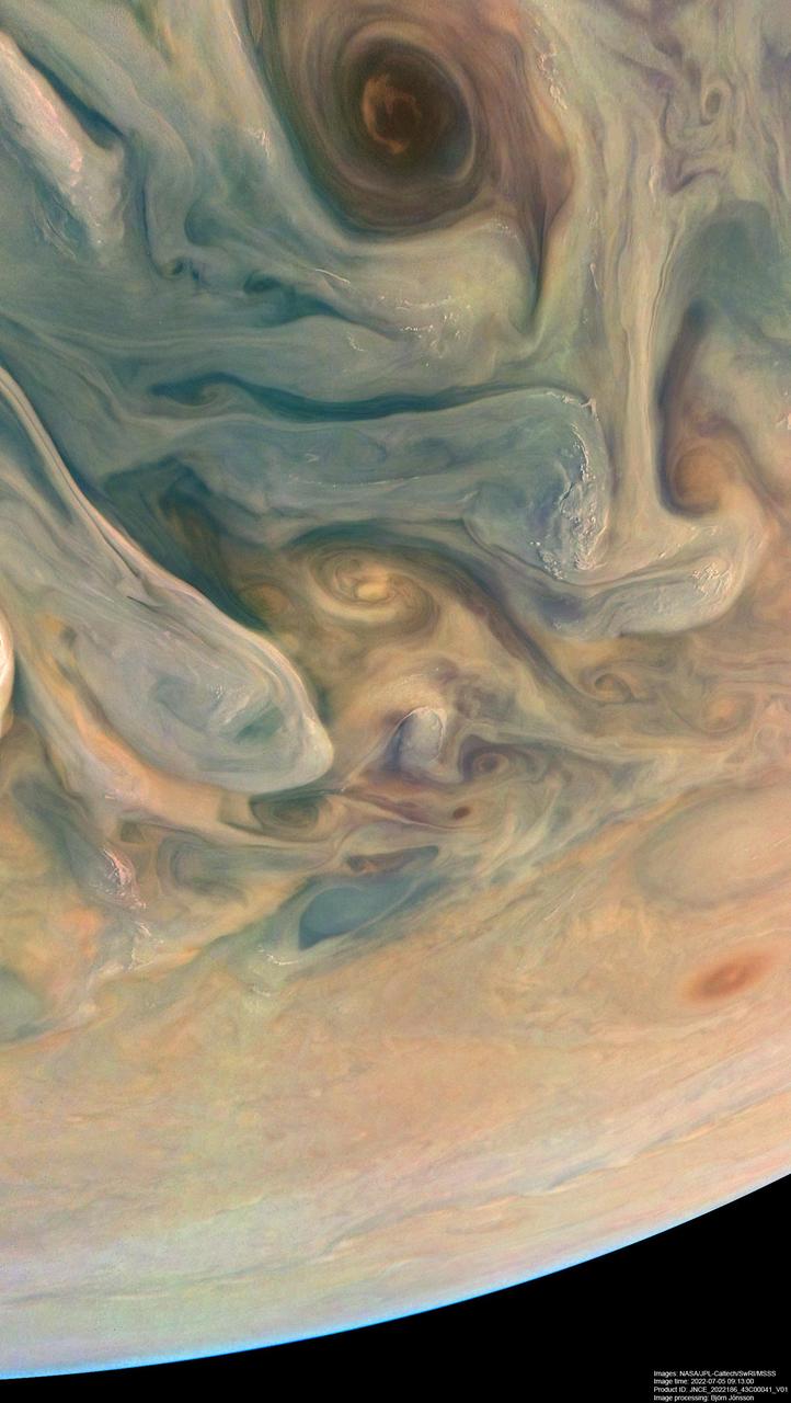 NASA's Juno spacecraft observed the complex colors and structure of Jupiter's clouds as it completed its 43rd close flyby of the giant planet on July 5, 2022.  Citizen scientist Björn Jónsson created these two images using raw data from the JunoCam instrument aboard the spacecraft. At the time the raw image was taken, Juno was about 3,300 miles (5,300 kilometers) above Jupiter's cloud tops, at a latitude of about 50 degrees. North is up. At that moment, the spacecraft was traveling at about 130,000 mph (209,000 kilometers per hour) relative to the planet.  The image was digitally processed to increase both the color saturation and contrast to sharpen small-scale features and to reduce compression artifacts and noise that typically appear in raw images. This clearly reveals some of the most intriguing aspects of Jupiter's atmosphere, including color variation that results from differing chemical composition, the three-dimensional nature of Jupiter's swirling vortices, and the small, bright "pop-up" clouds that form in the higher parts of the atmosphere.  https://photojournal.jpl.nasa.gov/catalog/PIA25018