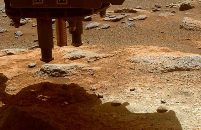 The robotic arm on NASA's Perseverance Mars rover used its percussive drill to eject fragments of cored rock from a sample tube on Jan. 15, 2022, the 322nd Martian day, or sol, of the mission. One of the rover's hazard cameras (hazcam) obtained same-day, before-and-after images of the surface below the rover to help better understand the results of this operation. There are two versions of the image: Animation frame 1 shows the ground below Perseverance prior to the use of the rover's percussive drill on Jan. 15. Animation frame 2 shows the same ground later that same day, after the percussive drill was employed. In this second image, at least eight new pieces of rock fragments can be seen. A key objective for Perseverance's mission on Mars is astrobiology, including the search for signs of ancient microbial life. The rover will characterize the planet's geology and past climate, pave the way for human exploration of the Red Planet, and be the first mission to collect and cache Martian rock and regolith (broken rock and dust). Subsequent NASA missions, in cooperation with ESA (European Space Agency), would send spacecraft to Mars to collect these sealed samples from the surface and return them to Earth for in-depth analysis. The Mars 2020 Perseverance mission is part of NASA's Moon to Mars exploration approach, which includes Artemis missions to the Moon that will help prepare for human exploration of the Red Planet. Animation available at https://photojournal.jpl.nasa.gov/catalog/PIA25070