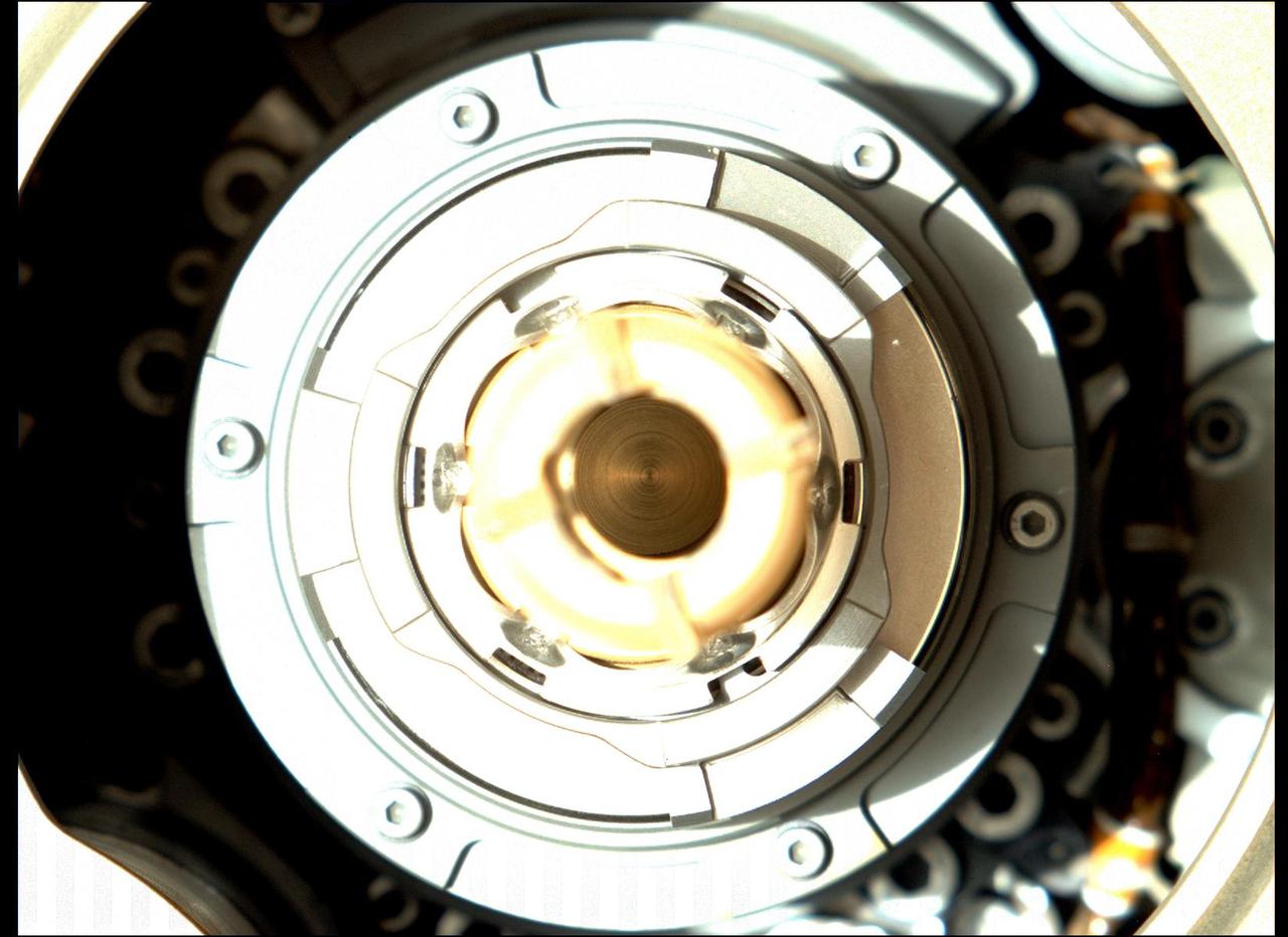 This image taken by the Mastcam-Z camera aboard NASA's Perseverance Mars rover on Jan. 20, 2022, shows that the rover successfully expelled the remaining large fragments of cored rock from a sample tube held in the drill at the end of its robotic arm. The sample was originally collected by the rover on Dec. 29, 2021, from a rock the team calls "Issole."  This image has been processed to enhance contrast.  Arizona State University in Tempe leads the operations of the Mastcam-Z instrument, working in collaboration with Malin Space Science Systems in San Diego.  A key objective for Perseverance's mission on Mars is astrobiology, including the search for signs of ancient microbial life. The rover will characterize the planet's geology and past climate, pave the way for human exploration of the Red Planet, and be the first mission to collect and cache Martian rock and regolith (broken rock and dust).  The Mars 2020 Perseverance mission is part of NASA's Moon to Mars exploration approach, which includes Artemis missions to the Moon that will help prepare for human exploration of the Red Planet.  https://photojournal.jpl.nasa.gov/catalog/PIA25073