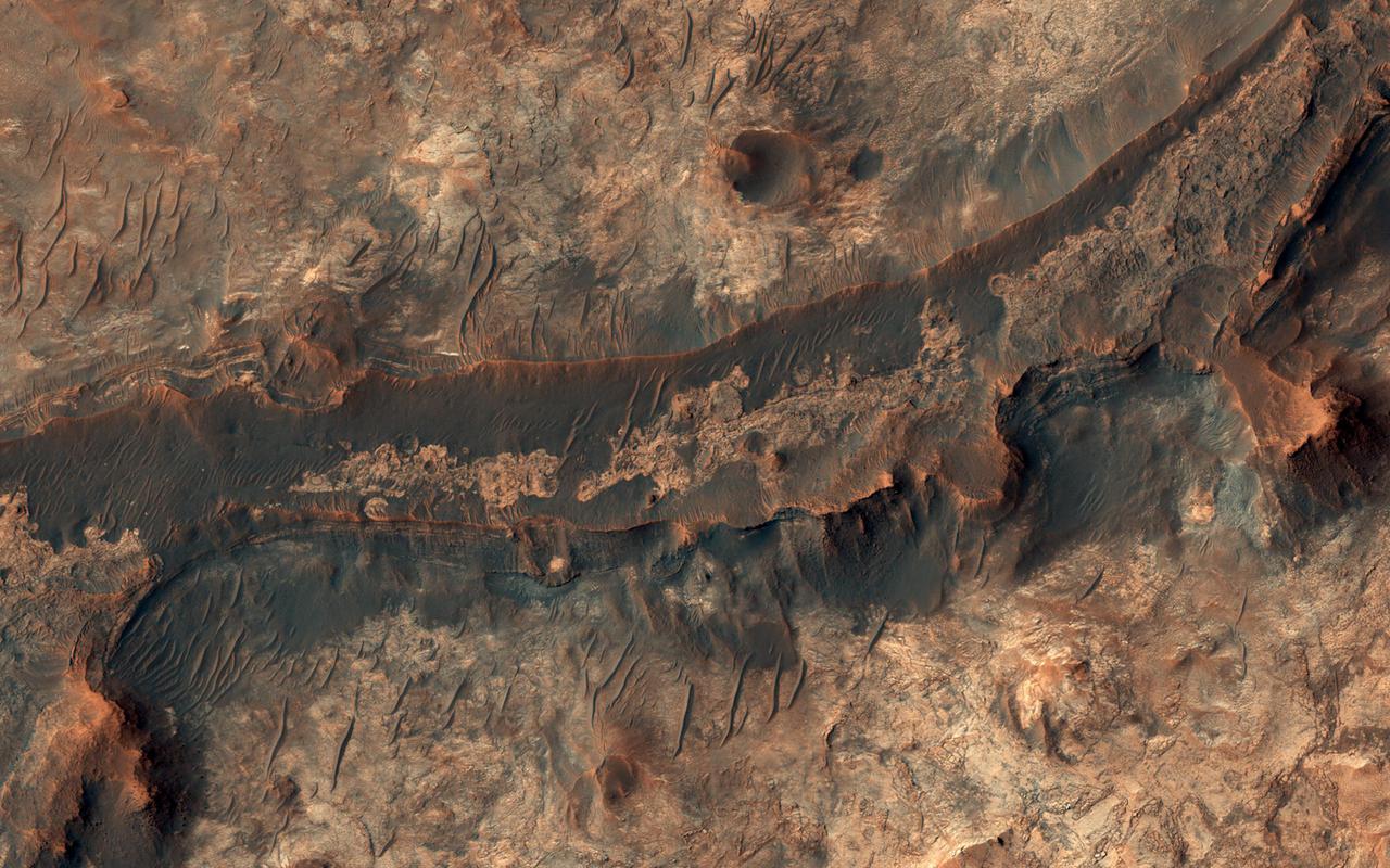 Billions of years ago, a river flowed across this scene in Mawrth Vallis. Like on Earth, these river beds can get filled up with rocks that are cemented together. After Mars became a colder, drier place and the river disappeared, the rocky river bed remained.  In this HiRISE image, we see a dark ridge snaking across the surface. The dark ridge is the old river bed. It is raised above its surroundings now because these softer surroundings have been eroded away, whereas the rocky river bed resists that. Scientists call these ridges inverted channels and many of them are visible in this area of Mars.   https://photojournal.jpl.nasa.gov/catalog/PIA25081