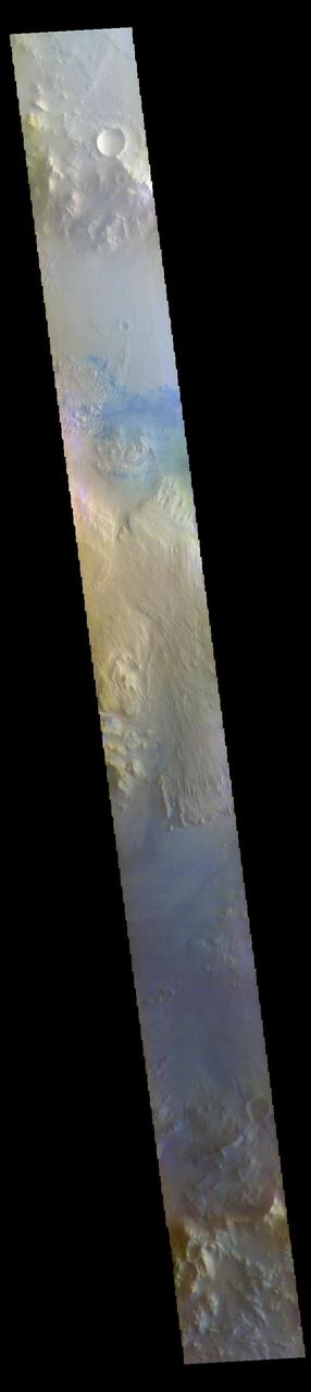 The THEMIS VIS camera contains 5 filters. The data from different filters can be combined in multiple ways to create a false color image. These false color images may reveal subtle variations of the surface not easily identified in a single band image. Today's false color image shows a cross section of Gale Crater, including the large layered deposit in the center of the crater. The Curiosity Rover is located on the floor of Gale Crater. Gale Crater is 154 km (95 miles) in diameter and is located near Terra Cimmeria.  The THEMIS VIS camera is capable of capturing color images of the Martian surface using five different color filters. In this mode of operation, the spatial resolution and coverage of the image must be reduced to accommodate the additional data volume produced from using multiple filters. To make a color image, three of the five filter images (each in grayscale) are selected. Each is contrast enhanced and then converted to a red, green, or blue intensity image. These three images are then combined to produce a full color, single image. Because the THEMIS color filters don't span the full range of colors seen by the human eye, a color THEMIS image does not represent true color. Also, because each single-filter image is contrast enhanced before inclusion in the three-color image, the apparent color variation of the scene is exaggerated. Nevertheless, the color variation that does appear is representative of some change in color, however subtle, in the actual scene. Note that the long edges of THEMIS color images typically contain color artifacts that do not represent surface variation.  Orbit Number: 85710 Latitude: -5.28449 Longitude: 138.202 Instrument: VIS Captured: 2021-04-10 16:02  https://photojournal.jpl.nasa.gov/catalog/PIA25092