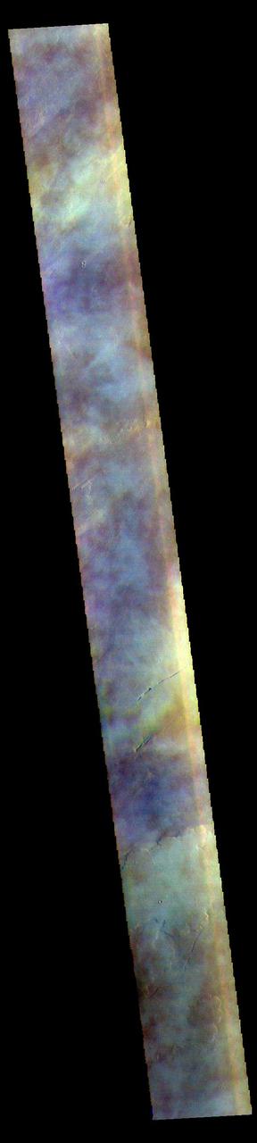 The THEMIS VIS camera contains 5 filters. The data from different filters can be combined in multiple ways to create a false color image. These false color images may reveal subtle variations of the surface not easily identified in a single band image. Today's false color image shows part of the vast volcanic plains in the Tharsis region, in this case east of Pavonis Mons. The mottled appearance of the image is being caused by high altitude cloud cover. These clouds will be primarily composed of ice rather than dust. The THEMIS VIS camera is capable of capturing color images of the Martian surface using five different color filters. In this mode of operation, the spatial resolution and coverage of the image must be reduced to accommodate the additional data volume produced from using multiple filters. To make a color image, three of the five filter images (each in grayscale) are selected. Each is contrast enhanced and then converted to a red, green, or blue intensity image. These three images are then combined to produce a full color, single image. Because the THEMIS color filters don't span the full range of colors seen by the human eye, a color THEMIS image does not represent true color. Also, because each single-filter image is contrast enhanced before inclusion in the three-color image, the apparent color variation of the scene is exaggerated. Nevertheless, the color variation that does appear is representative of some change in color, however subtle, in the actual scene. Note that the long edges of THEMIS color images typically contain color artifacts that do not represent surface variation. Orbit Number: 85818 Latitude: 6.41017 Longitude: 260.984 Instrument: VIS Captured: 2021-04-19 13:31 https://photojournal.jpl.nasa.gov/catalog/PIA25096