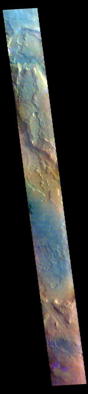 The THEMIS VIS camera contains 5 filters. The data from different filters can be combined in multiple ways to create a false color image. These false color images may reveal subtle variations of the surface not easily identified in a single band image. Today's false color image shows part of Margaritifer Terra just east of Ares Vallis. If you look closely at the bottom of the image, you will see spots of purple and yellow, with similar 'shapes'. These features are not image artifacts. These are clouds. When this image was collected there were high altitude ice clouds being blown across the sky, moving fast enough to reach a different location between the time each filter was collected. Color VIS images are typically the only image type where ice clouds can be identified. The THEMIS VIS camera is capable of capturing color images of the Martian surface using five different color filters. In this mode of operation, the spatial resolution and coverage of the image must be reduced to accommodate the additional data volume produced from using multiple filters. To make a color image, three of the five filter images (each in grayscale) are selected. Each is contrast enhanced and then converted to a red, green, or blue intensity image. These three images are then combined to produce a full color, single image. Because the THEMIS color filters don't span the full range of colors seen by the human eye, a color THEMIS image does not represent true color. Also, because each single-filter image is contrast enhanced before inclusion in the three-color image, the apparent color variation of the scene is exaggerated. Nevertheless, the color variation that does appear is representative of some change in color, however subtle, in the actual scene. Note that the long edges of THEMIS color images typically contain color artifacts that do not represent surface variation. Orbit Number: 85890 Latitude: 2.8487 Longitude: 344.415 Instrument: VIS Captured: 2021-04-25 11:47 https://photojournal.jpl.nasa.gov/catalog/PIA25097