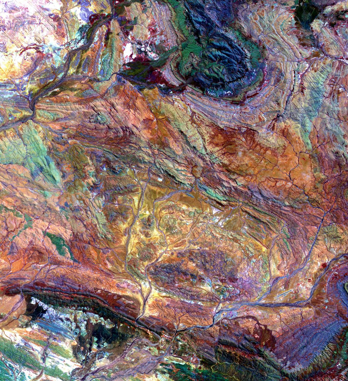 The Pilbara in northwestern Australia exposes some of the oldest rocks on Earth, over 3.6 billion years old. The iron-rich rocks formed before the presence of atmospheric oxygen, and life itself. Found upon these rocks are 3.45 billion-year-old fossil stromatolites, colonies of microbial cyanobacteria. The image is a composite of ASTER bands 4-2-1 displayed in RGB. The image was acquired October 12, 2004, covers an area of 49.1 by 55.2 km, and is located at 22.8 degrees south, 117.6 degrees east. https://photojournal.jpl.nasa.gov/catalog/PIA25122
