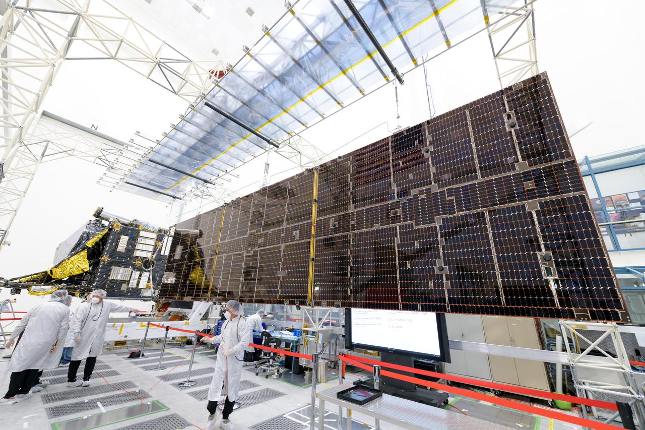Engineers at NASA's Jet Propulsion Laboratory in Southern California successfully deployed a solar array installed on the agency's Psyche spacecraft. It was one of two deployed during testing in the Lab's High Bay 2 clean room in late February 2022.  The twin arrays are together about 800 square feet (75 square meters) – the largest ever deployed at JPL. Part of a solar electric propulsion system provided by Maxar Technologies, they will power the spacecraft on its 1.5 billion-mile (2.4 billion-kilometer) journey to the large, metal-rich asteroid Psyche.  Only the three center panels on each five-panel, cross-shaped array can be deployed at JPL due to the limitations of the gravity-offload fixture and the opposing direction of rotation of the cross panels. Deployment of the two cross panels was previously performed at Maxar with different equipment. After further spacecraft testing is completed at JPL, the arrays will be removed and returned to Maxar in order to repeat the cross-panel deployments, make any final repairs to the solar cells, and test overall performance. The arrays then get shipped from Maxar to NASA's Kennedy Space Center in Florida, where they will be reintegrated onto the spacecraft in preparation for launch in August 2022.  About an hour after launch, Psyche will deploy the arrays sequentially, first unfolding the three lengthwise center panels, then the two cross panels on one wing before repeating the process with the other wing. Each array takes about 7 ½ minutes to unfurl and latch into place.  Each array is 37.1 feet (11.3 meters) long and 24 feet (7.3 meters) wide when fully deployed. With arrays deployed on either side of the chassis, the spacecraft is about the size of a singles tennis court: 81 feet long (24.7 meters) and 24 feet (7.3 meters) wide.  https://photojournal.jpl.nasa.gov/catalog/PIA25135