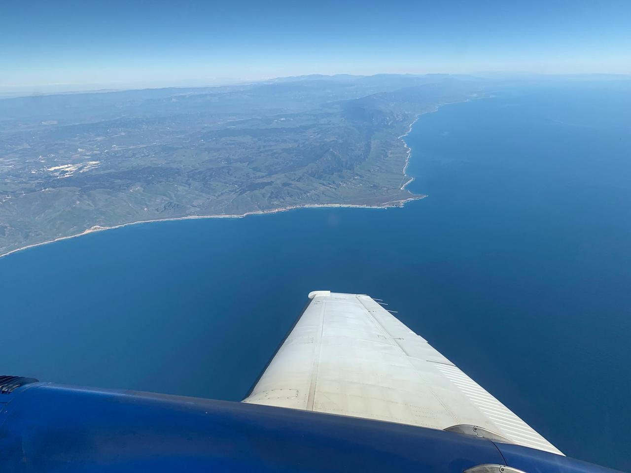 A research plane carrying the AVIRIS-NG (Airborne Visible/Infrared Imaging Spectrometer-Next Generation) instrument flies off the Central Coast of California near Point Conception and the Jack and Laura Dangermond Preserve on Feb. 24, 2022. The flight is part of the Surface Biology and Geology High-Frequency Time Series (SHIFT) campaign, which is jointly led by NASA's Jet Propulsion Laboratory, the University of California, Santa Barbara (UCSB), and The Nature Conservancy.      Operating between late February and late May 2022, the aerial portion of SHIFT flies on an approximately weekly basis over a 640-square-mile (1,656-square-kilometer) study area in Santa Barbara County and the nearby ocean, collecting spectral data of plant communities it observes below. SHIFT combines the ability of airborne science instruments to gather data over widespread areas with the more concentrated observations scientists conduct in the field to study the functional characteristics, health, and resilience of plant communities.      The sampling and analysis done by researchers on the ground and in the ocean is intended to validate data taken by AVIRIS-NG and help scientists design data collection and processing algorithms for NASA's proposed Surface Biology and Geology (SBG) mission, which would launch no earlier than 2028. The data is also intended to support the research and conservation objectives of The Nature Conservancy, which owns the Dangermond Preserve, and UCSB, which operates the Sedgwick Reserve, another nature preserve within the study area. More than 60 scientists from institutions around the U.S. have indicated they intend to use the SHIFT data in their research.      AVIRIS-NG, which was designed at JPL, flies aboard Dynamic Aviation's King Air B-200.  https://photojournal.jpl.nasa.gov/catalog/PIA25143
