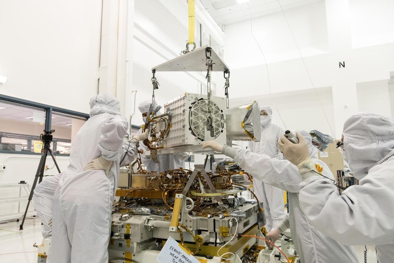 Engineers and technicians at NASA's Jet Propulsion Laboratory in Southern California assemble components of the Earth Surface Mineral Dust Source Investigation (EMIT) mission instrument in December 2021. The upper portion consists of EMIT's optical subsystem, including a telescope and imaging spectrometer, while the baseplate below holds electronics.  EMIT will collect measurements of 10 important surface minerals – hematite, goethite, illite, vermiculite, calcite, dolomite, montmorillonite, kaolinite, chlorite, and gypsum – in arid regions between 50-degree south and north latitudes in Africa, Asia, North and South America, and Australia. The data EMIT collects will help scientists better understand the role of airborne dust particles in heating and cooling Earth's atmosphere on global and regional scales.  https://photojournal.jpl.nasa.gov/catalog/PIA25146