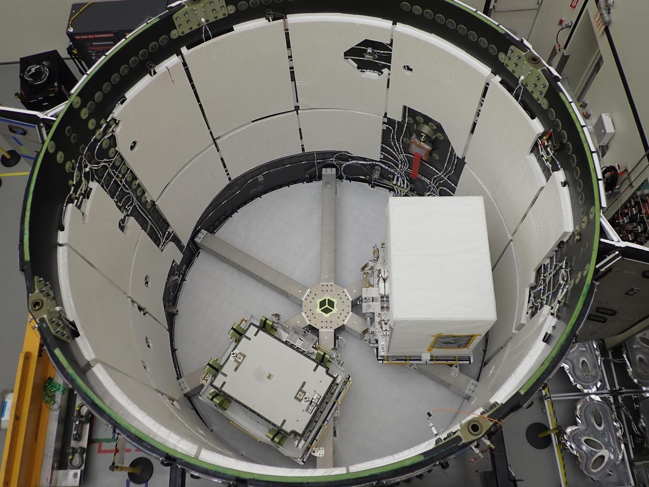 The Earth Surface Mineral Dust Source Investigation (EMIT) mission instrument (right) sits in the "trunk" that will travel aboard SpaceX's 25th cargo resupply mission – planned for June 7, 2022 – to the International Space Station. This image was taken May 3, 2022, at SpaceX's Dragonland facility in Florida. Developed at NASA's Jet Propulsion Laboratory in Southern California and launching from Kennedy Space Center in Florida, EMIT will map the world's mineral-dust sources, gathering information about particle color and composition as it orbits over the planet's dry, sparsely vegetated regions.      After being mounted on the space station, EMIT will collect measurements of 10 important surface minerals – hematite, goethite, illite, vermiculite, calcite, dolomite, montmorillonite, kaolinite, chlorite, and gypsum – in arid regions between 50-degree south and north latitudes in Africa, Asia, North and South America, and Australia. The data EMIT collects will help scientists better understand the role of airborne dust particles in heating and cooling Earth's atmosphere on global and regional scales.      The white covering will prevent the spread of the heat the instrument generates, keeping it from affecting the space station and nearby instruments.      EMIT will be one of two pieces of equipment transported to the space station in the external cargo "trunk" on SpaceX's Falcon 9 rocket. The other (left) is a Battery Charge/Discharge Unit.  https://photojournal.jpl.nasa.gov/catalog/PIA25148