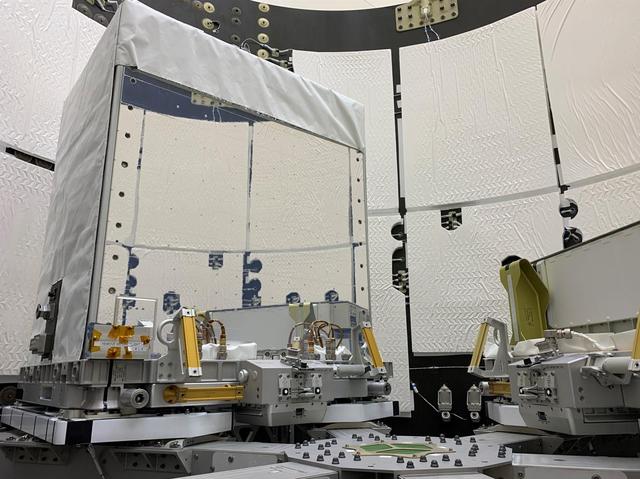 The Earth Surface Mineral Dust Source Investigation (EMIT) mission instrument (left) sits in the "trunk" that will travel aboard SpaceX's 25th cargo resupply mission – planned for June 7, 2022 – to the International Space Station. This image was taken May 3, 2022, at SpaceX's Dragonland facility in Florida. Developed at NASA's Jet Propulsion Laboratory in Southern California and launching from Kennedy Space Center in Florida, EMIT will map the world's mineral-dust sources, gathering information about particle color and composition as it orbits over the planet's dry, sparsely vegetated regions.      After being mounted on the space station, EMIT will collect measurements of 10 important surface minerals – hematite, goethite, illite, vermiculite, calcite, dolomite, montmorillonite, kaolinite, chlorite, and gypsum – in arid regions between 50-degree south and north latitudes in Africa, Asia, North and South America, and Australia. The data EMIT collects will help scientists better understand the role of airborne dust particles in heating and cooling Earth's atmosphere on global and regional scales.      The mirror-like side radiator panels are designed to keep the instrument's interior electronics and optics at a low enough temperature to work optimally. The white covering will prevent the spread of the heat the instrument generates, keeping it from affecting the space station and nearby instruments.      EMIT will be one of two pieces of equipment transported to the space station in the external cargo "trunk" on SpaceX's Falcon 9 rocket. The other (left) is a Battery Charge/Discharge Unit.  https://photojournal.jpl.nasa.gov/catalog/PIA25149