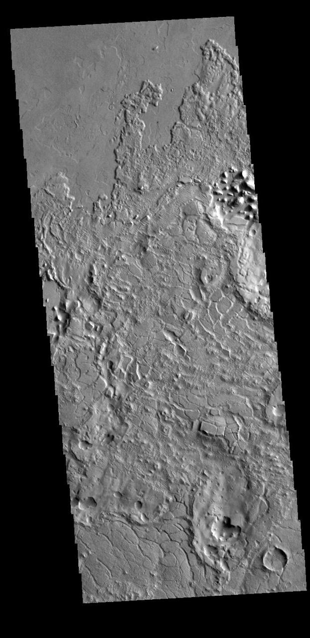 Called Avernus Colles, these broken blocks and arcuate fractures mark the transition region between the southern highlands and the northern lowlands of Mars north of Apollinaris Mons, on the margin with Elysium Planitia.  Orbit Number: 88167 Latitude: 1.23136 Longitude: 175.576 Instrument: VIS Captured: 2021-10-29 23:24  https://photojournal.jpl.nasa.gov/catalog/PIA25155