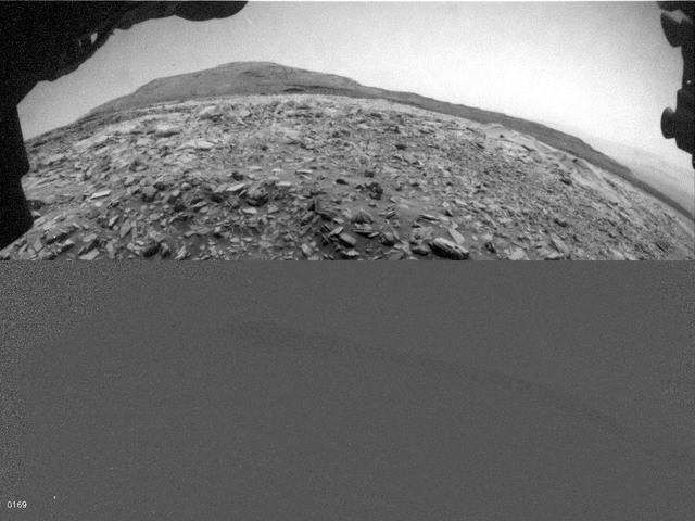 NASA's Curiosity Mars rover used one of its Hazard-Avoidance Cameras (Hazcams) to catch this dusty wind gust blowing overhead on March 18, 2022, the 3,418th Martian day, or sol, of the mission. Scientists believe it's a wind gust rather than a dust devil since it doesn't appear to have the trademark vorticity, or twisting, of a dust devil. The series of images captured by the Hazcam is viewable in the top image; the bottom image shows the frames after they've been processed by change-detection software, which helps the viewer see how the wind gust moves over time. Movie available at https://photojournal.jpl.nasa.gov/catalog/PIA25177