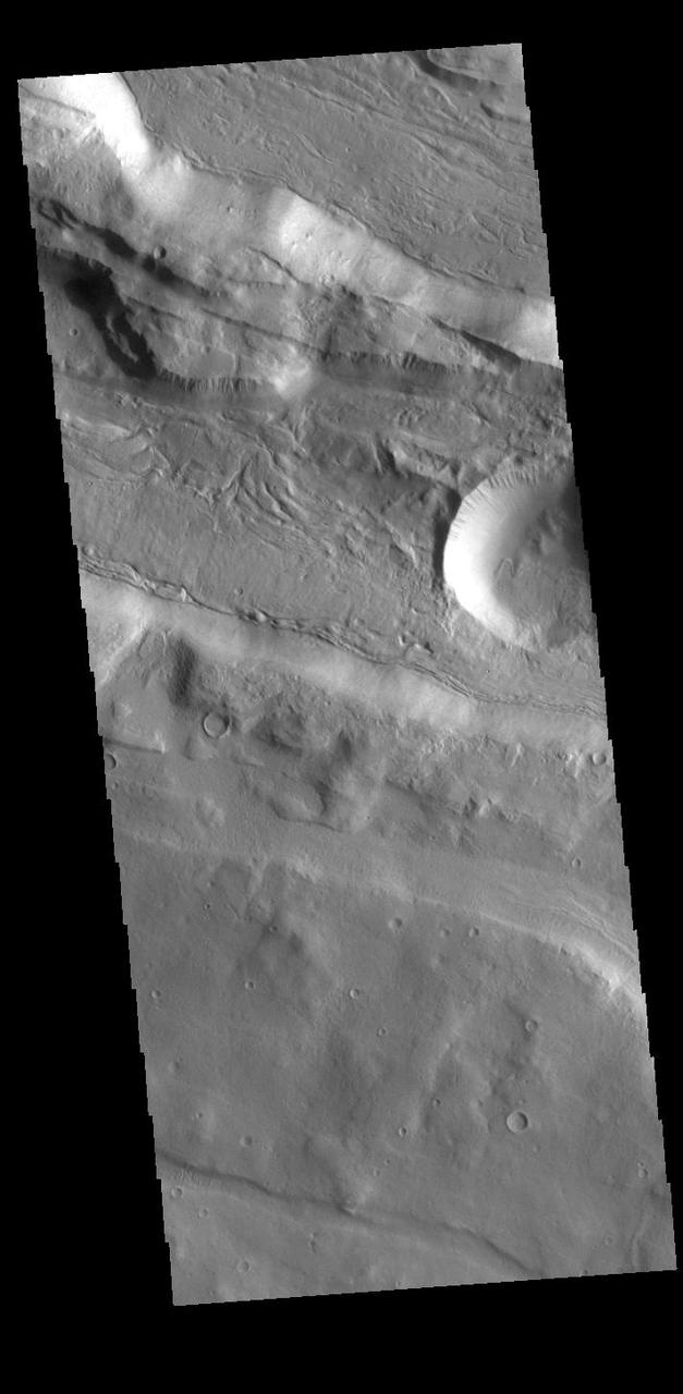 This VIS shows part of Acheron Fossae. Acheron Fossae is the highly fractured, faulted and deformed terrain located 1,050 kilometers (650 miles) north of the large shield volcano Olympus Mons. Lava flows from Olympus Mons at the base of Acheron Fossae show that the fossae predate the flows. The scarps visible in this image are approximately one kilometer (3,300 feet) high.  Orbit Number: 88190 Latitude: 37.8893 Longitude: 226.816 Instrument: VIS Captured: 2021-10-31 21:03  https://photojournal.jpl.nasa.gov/catalog/PIA25191