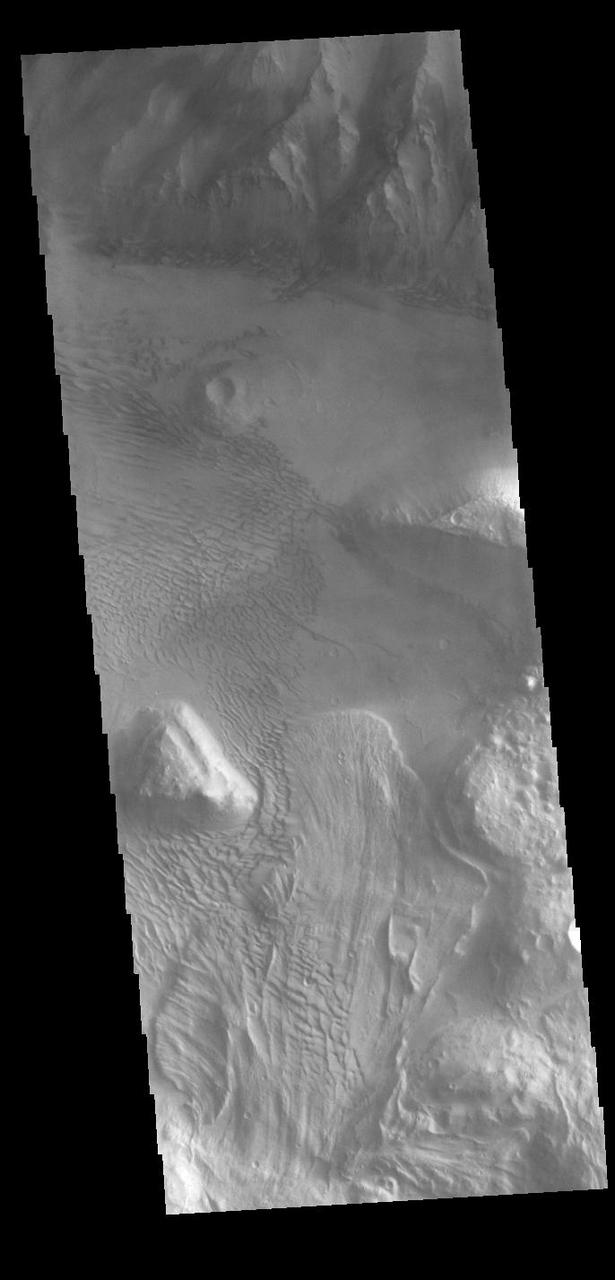 This VIS image is located on the eastern side of Coprates Chasma, near Capri Chasma. The image shows a large lobe shaped landslide deposit at the bottom of the canyon cliff face. Sand dunes are visible both on the landslide deposit and other parts of the canyon floor. Coprates Chasma is one of the numerous canyons that make up Valles Marineris. The chasma stretches for 960 km (600 miles) from Melas Chasma to the west and Capri Chasma to the east. Landslide deposits, layered materials and sand dunes cover a large portion of the chasma floor.  Orbit Number: 88225 Latitude: -15.0285 Longitude: 304.496 Instrument: VIS Captured: 2021-11-03 17:56  https://photojournal.jpl.nasa.gov/catalog/PIA25196