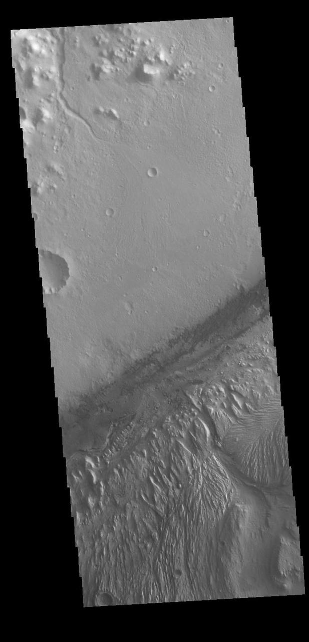Today's VIS image shows a cross section of Gale Crater, including part of the large layered deposit on the crater floor. This deposit has been heavily eroded. The Curiosity Rover is located in Gale Crater. Gale crater is 150km (90 miles) in diameter. Orbit Number: 86908 Latitude: -4.63872 Longitude: 137.343 Instrument: VIS Captured: 2021-07-18 07:25 https://photojournal.jpl.nasa.gov/catalog/PIA25203