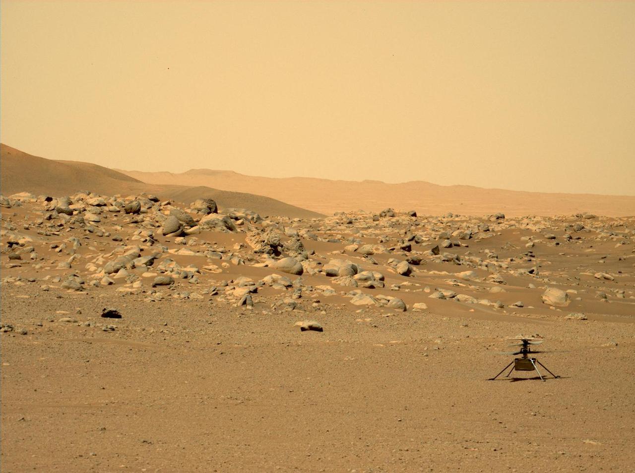 This image of NASA's Ingenuity Mars Helicopter was taken by the Mastcam-Z instrument of the Perseverance rover on June 15, 2021, the 114th Martian day, or sol, of the mission. The location, "Airfield D" (the fourth airfield), is just east of the "Séítah" geologic unit.  The image has been processed from the original version.  Ingenuity was built by NASA's Jet Propulsion Laboratory in Southern California, which also manages the project for NASA Headquarters. It is supported by NASA's Science Mission Directorate. NASA's Ames Research Center in California's Silicon Valley, and NASA's Langley Research Center in Hampton, Virginia, provided significant flight performance analysis and technical assistance during Ingenuity's development. AeroVironment Inc., Qualcomm, and SolAero also provided design assistance and major vehicle components. Lockheed Martin Space designed and manufactured the Mars Helicopter Delivery System.  A key objective for Perseverance's mission on Mars is astrobiology, including the search for signs of ancient microbial life. The rover will characterize the planet's geology and past climate, pave the way for human exploration of the Red Planet, and be the first mission to collect and cache Martian rock and regolith (broken rock and dust).  Subsequent NASA missions, in cooperation with ESA (European Space Agency), would send spacecraft to Mars to collect these sealed samples from the surface and return them to Earth for in-depth analysis.  https://photojournal.jpl.nasa.gov/catalog/PIA25213