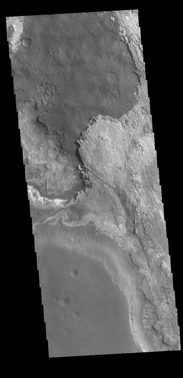 This VIS image shows layering of surface materials in Meridiani Planum. TES (Thermal Emission Spectrometer) initially detected hematite in a surface layer, which was confimed by THEMIS (THermal EMision Imaging System). These findings supported a water rich origin of the hematite and led to the selection of the site for the Opportunity MER (Mars Exploration Rover). Orbit Number: 87337 Latitude: 1.58599 Longitude: 0.436954 Instrument: VIS Captured: 2021-08-22 15:12 https://photojournal.jpl.nasa.gov/catalog/PIA25221