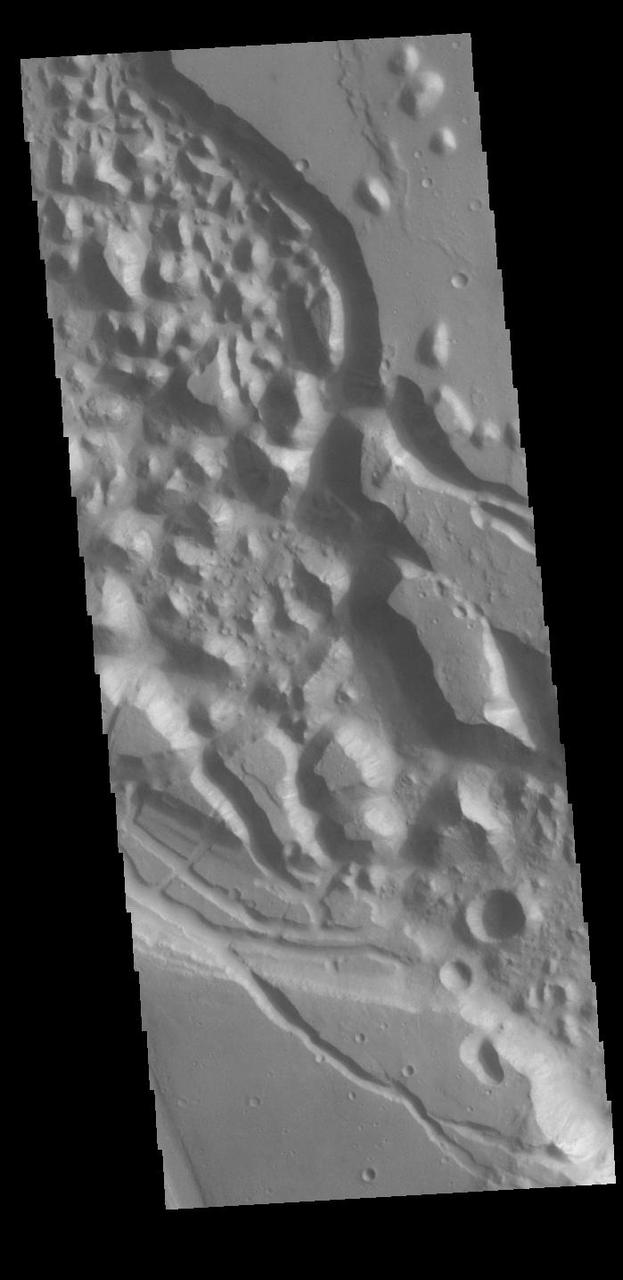 Today's VIS image shows Xanthe Chaos, a region of knobs and mesas within the channel of Shalbatana Vallis.  In planetary nomenclature, the descriptor term chaos means "distinctive area of broken terrain". The general morphology of chaos is steep-sided mesas with intervening small valleys. With time and erosion the valleys widen and the mesas grow smaller. While on many planets chaos terrain results from tectonic forces, on Mars it is most likely that chaos terrain results from the release of melted subsurface ice.  Orbit Number: 87588 Latitude: 11.818 Longitude: 317.879 Instrument: VIS Captured: 2021-09-12 07:17  https://photojournal.jpl.nasa.gov/catalog/PIA25225