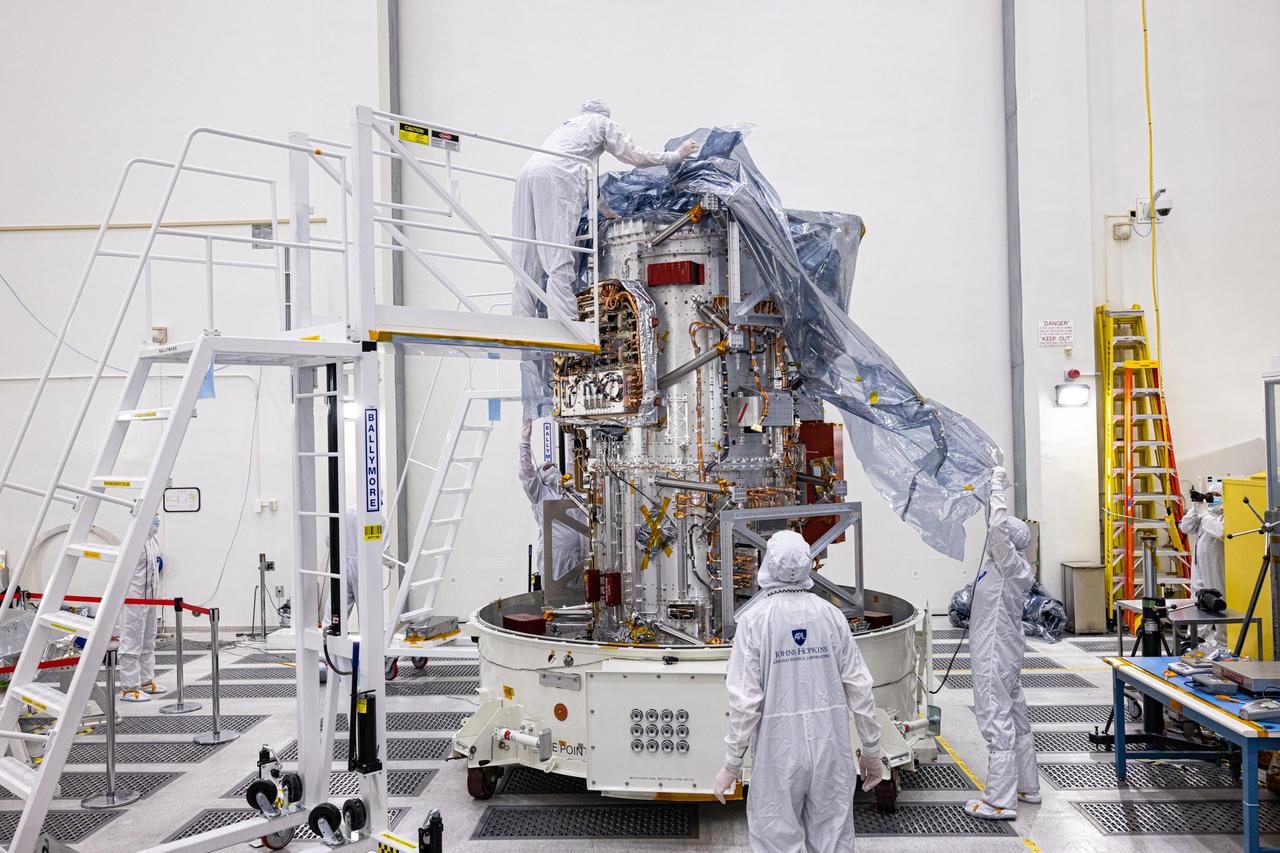 The main body of NASA's Europa Clipper spacecraft has been delivered to the agency's Jet Propulsion Laboratory in Southern California, where, over the next two years, engineers and technicians will finish assembling the craft by hand before testing it to make sure it can withstand the journey to Jupiter's icy moon Europa. Here it is being unwrapped in a main clean room at JPL, as engineers and technicians inspect it just after delivery in early June 2022.  The Johns Hopkins Applied Physics Laboratory (APL) in Laurel, Maryland, designed and built the spacecraft body in collaboration with JPL and NASA's Goddard Space Flight Center in Greenbelt, Maryland.  Set to launch in October 2024, Europa Clipper will conduct nearly 50 flybys of Europa, which scientists are confident harbors an internal ocean containing twice as much water as Earth's oceans combined. And the moon may currently have conditions suitable for supporting life. The spacecraft's nine science instruments will gather data on the moon's atmosphere, surface, and interior – information that scientists will use to gauge the depth and salinity of the ocean, the thickness of the ice crust, and potential plumes that may be venting subsurface water into space.  https://photojournal.jpl.nasa.gov/catalog/PIA25237