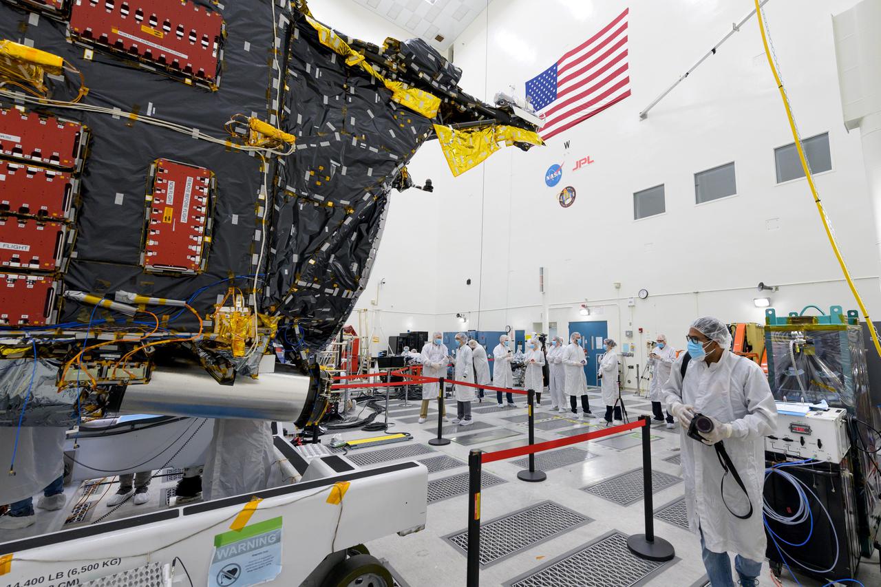 Members of the media view the Psyche spacecraft on April 11, 2022, inside a clean room at JPL. The spacecraft is scheduled to launch in August on a journey to a metal-rich asteroid of the same name.  https://photojournal.jpl.nasa.gov/catalog/PIA25242