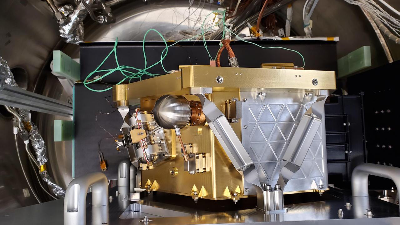 The High-resolution Volatiles and Minerals Moon Mapper (HVM³), seen here, is one of two instruments that will be carried aboard NASA's Lunar Trailblazer. Launching in 2023, the small spacecraft – measuring only 11.5 feet (3.5 meters) wide with its solar panels fully deployed – will detect and map water on the Moon's surface to determine its abundance, location, form, and how it changes over time.  HVM³ recently completed a significant milestone in a clean room at NASA's Jet Propulsion Laboratory in Southern California. The high-resolution spectrometer measures the infrared light (with wavelengths from 0.6 to 3.6 microns in size) that is absorbed by water. To make sure the instrument is properly aligned, the Trailblazer team cooled HVM3 down to temperatures it will experience in space and made tiny physical adjustments to make sure all the wavelengths of incoming light arrive at the correct locations on the instrument's detector.  Figure A shows several members of the Trailblazer team surrounding the instrument – minus its radiator and electronics – mounted on HVM³'s optical bench assembly while undergoing cold alignment.  The assembly was placed inside a thermal vacuum chamber and brought to a cold focal plane operating temperature of about minus 240 degrees Fahrenheit (minus 155 degrees Celsius). The team then measured light of different wavelengths across all of the detector's pixels. Based on the data recorded, the team calculated the small adjustments that needed to be made, took the instrument out of the chamber and made those changes, placed it back into the chamber, and then repeated the steps iteratively until HVM³ was in perfect alignment.  With this important step complete, a radiator will next be installed to ensure the instrument maintains optimal operating temperatures while Trailblazer is in orbit around the Moon. Then, vibration tests will be carried out to make sure the spectrometer will stay in alignment after the extreme shaking of launch.  Lunar Trailblazer was selected to be part of NASA's SIMPLEx (Small Innovative Missions for Planetary Exploration) program in 2019. The mission is led by Caltech in Pasadena, California, and managed by JPL.  https://photojournal.jpl.nasa.gov/catalog/PIA25252