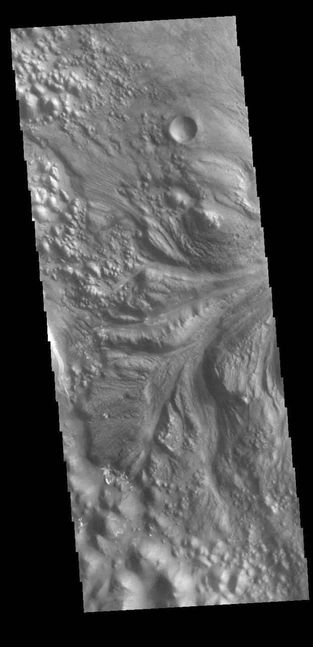 Today's VIS image shows part of Aram Chaos right at the outflow channel that connects to Ares Vallis. Aram Chaos was initially formed by a large impact. Over time the crater interior was modified by several different processes, including liquid water. This narrow channel links the Aram Chaos crater with the northward flowing Ares Vallis and indicates a substantial amount of water was located in the crater. Aram Chaos is 280 km (175 miles) in diameter. Orbit Number: 87737 Latitude: 2.57814 Longitude: 340.64 Instrument: VIS Captured: 2021-09-24 13:40 https://photojournal.jpl.nasa.gov/catalog/PIA25265