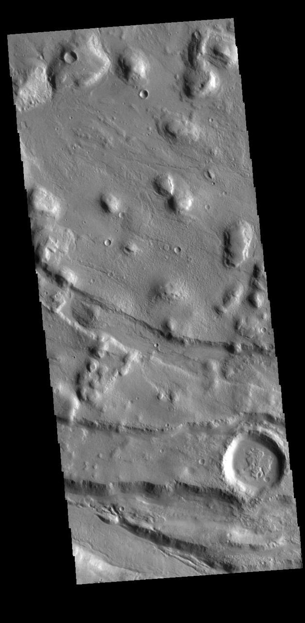 This VIS image shows part of Acheron Fossae. Acheron Fossae is the highly fractured, faulted and deformed terrain located 1,050 kilometers (650 miles) north of the large shield volcano Olympus Mons. Lava flows from Olympus Mons at the base of Acheron Fossae show that the fossae predate the flows.  Orbit Number: 87741 Latitude: 38.8782 Longitude: 220.025 Instrument: VIS Captured: 2021-09-24 21:46  https://photojournal.jpl.nasa.gov/catalog/PIA25266
