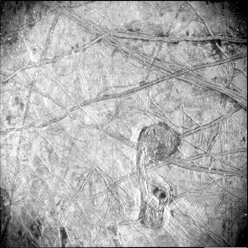 Taken by NASA's Juno spacecraft, this black-and-white photo of the surface of Jupiter's icy moon Europa reveals a curious feature – shaped somewhat like the musical symbol for a quarter note – surrounded by a vast network of linear ridges and dark blotches. It was obtained by Juno's Stellar Reference Unit (SRU) during the spacecraft's Sept. 29, 2022, flyby of Europa.  The image shows a region crisscrossed with a network of fine grooves and sets of complicated double ridges (pairs of long parallel lines indicating elevated features in the ice). In the upper right corner are dark stains possibly linked to seepage or the bubbling up of liquid from beneath the ice. Just below center and to the right is the surface feature that takes a form like a musical quarter note. The feature measures 42 miles (67 kilometers) north-south and 23 miles (37 kilometers) east-west. The white dots in the image are signatures of penetrating high energy particles from the severe radiation environment around the moon.  The image was taken at a distance of about 256 miles (412 kilometers) over the darkened hemisphere of Europa. It covers about 93 miles (150 kilometers) by 125 miles (200 kilometers) of the moon's surface.  The SRU is designed to provide images of starfields used for attitude determination. The camera, designed for low-light conditions, has proved itself a valuable science tool, discovering shallow lightning in Jupiter's atmosphere, imaging Jupiter's enigmatic ring system, and now providing a glimpse of Europa's most fascinating geologic formations.  https://photojournal.jpl.nasa.gov/catalog/PIA25332