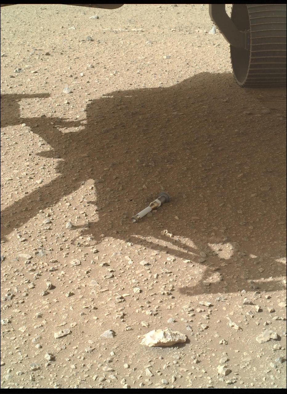 NASA's Perseverance Mars rover dropped the last of 10 tubes at the "Three Forks" sample depot on Jan. 28, 2023, the 690th Martian day, or sol, of the mission. This image of the 10th tube was taken by the WATSON (Wide Angle Topographic Sensor for Operations and eNgineering) camera on the end of the rover's 7-foot-long (2-meter-long) robotic arm.  This final sample is what's called a "witness" tube – one of three collected by the rover so far and the only one deposited at the depot. Witness tubes are similar to the sample tubes that hold Martian rock and sediment, except they have been preloaded with a variety of materials that can capture molecular and particulate contaminants. They are opened on the Martian surface to "witness" the ambient environment near sample collection sites. With samples returned to Earth in the future, the witness tubes would be used to determine if samples being collected might be contaminated with materials that traveled with the rover from Earth.  The Three Forks depot, the first sample depot on another world, is a crucial milestone in the NASA-ESA (European Space Agency) Mars Sample Return campaign, which aims to bring Mars samples to Earth for closer study. The Perseverance rover will be the primary means to convey the collected samples to a future robotic lander as part of the campaign. The lander would, in turn, use a robotic arm to place the samples in a containment capsule aboard a small rocket that would blast off to Mars orbit, where another spacecraft would capture the sample container and return it safely to Earth. Hosting the duplicate set, the Three Forks depot will serve as a backup if Perseverance can't deliver its samples.  A key objective for Perseverance's mission on Mars is astrobiology, including the search for signs of ancient microbial life. The rover will characterize the planet's geology and past climate, pave the way for human exploration of the Red Planet, and be the first mission to collect and cache Martian rock and regolith (broken rock and dust).  Subsequent NASA missions, in cooperation with ESA (European Space Agency), would send spacecraft to Mars to collect these sealed samples from the surface and return them to Earth for in-depth analysis.  The Mars 2020 Perseverance mission is part of NASA's Moon to Mars exploration approach, which includes Artemis missions to the Moon that will help prepare for human exploration of the Red Planet.  https://photojournal.jpl.nasa.gov/catalog/PIA25340