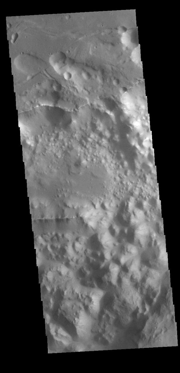 Today's VIS image shows a small section on Margaritifer Chaos. The term chaos is applied to regions where the surface is being eroded to form mesas. As the surface processes continue individual mesas become more isolated and take on the appearance of regions of hills. At the top of the image is Margaritifer Terra, which is being dissected into large mesas. Towards the bottom of the image the mesas have been eroded into smaller hills.  Orbit Number: 89010 Latitude: -7.22948 Longitude: 336.24 Instrument: VIS Captured: 2022-01-07 09:17  https://photojournal.jpl.nasa.gov/catalog/PIA25345