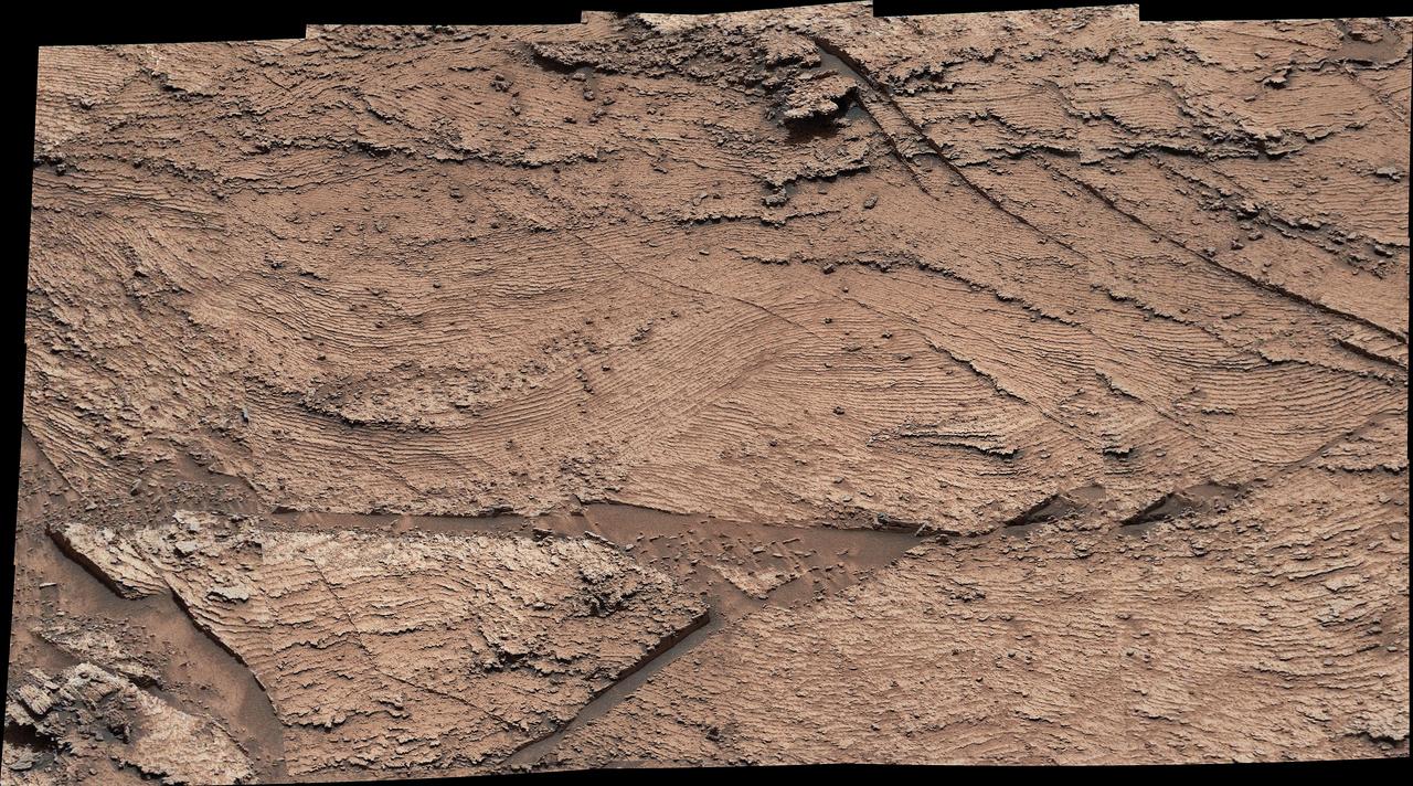 NASA's Curiosity Mars rover captured evidence of rock layers that built up as windblown sand accumulated in some areas and was scoured away in others in the ancient past. This panorama, made up of nine individual images that were later stitched together, was captured at a location nicknamed "Las Claritas" using Curiosity's Mast Camera, or Mastcam, on May 19, 2022, the 3,478th Martian day, or sol, of the mission.  https://photojournal.jpl.nasa.gov/catalog/PIA25369
