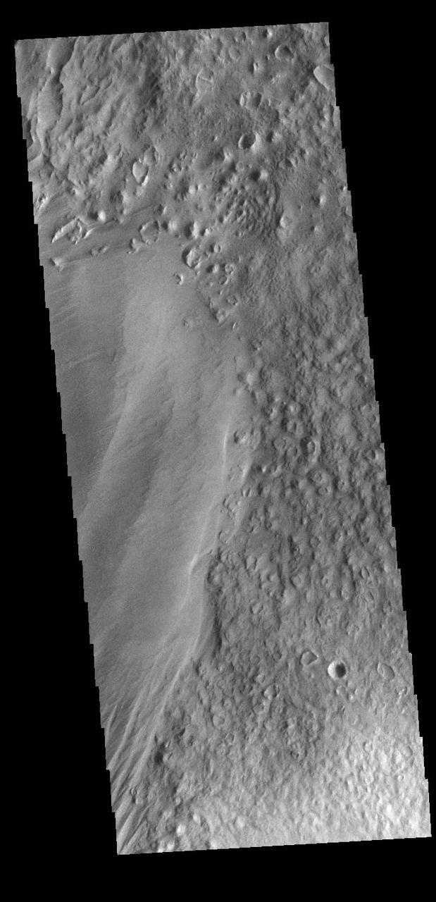 Eumenides Dorsum is a large linear rise located in southern Amazonis Planitia. Erosion by wind action is prevalent in this region. The materials of the dorsum are the smooth deposit along the left side of this VIS image. The rougher surface is part of the plains material that make up the majority of Amazonis Planitia.  Orbit Number: 89601 Latitude: -3.02574 Longitude: 205.311 Instrument: VIS Captured: 2022-02-25 01:14  https://photojournal.jpl.nasa.gov/catalog/PIA25400