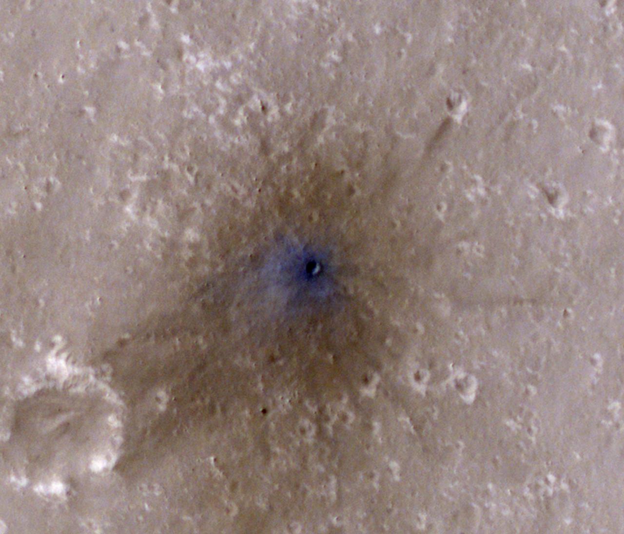 NASA's Mars Reconnaissance Orbiter captured this image of a meteoroid impact that was first detected by the agency's InSight lander using its seismometer. This crater was formed on Feb. 18, 2021. MRO's High Resolution Imaging Science Experiment (HiRISE) camera captured this scene in color. The ground is not actually blue; this enhanced-color image highlights certain hues in the scene to make details more visible to the human eye – in this case, dust and soil disturbed by the impact. https://photojournal.jpl.nasa.gov/catalog/PIA25409
