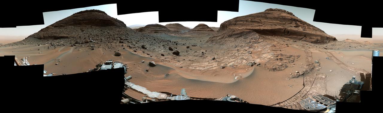 NASA's Curiosity Mars rover used its Mast Camera, or Mastcam, to capture this panorama while driving toward the center of this scene, an area that forms the narrow "Paraitepuy Pass," on Aug. 14, the 3,563rd Martian day, or sol, of the mission. The hill on the right is "Bolívar"; on the left of is "Deepdale." The floor of the vast Gale Crater is visible in the background in the upper right.  This panorama was stitched together from 146 images after they were sent back to Earth. The color has been adjusted to match the lighting conditions as the human eye would perceive them on Earth.  https://photojournal.jpl.nasa.gov/catalog/PIA25413