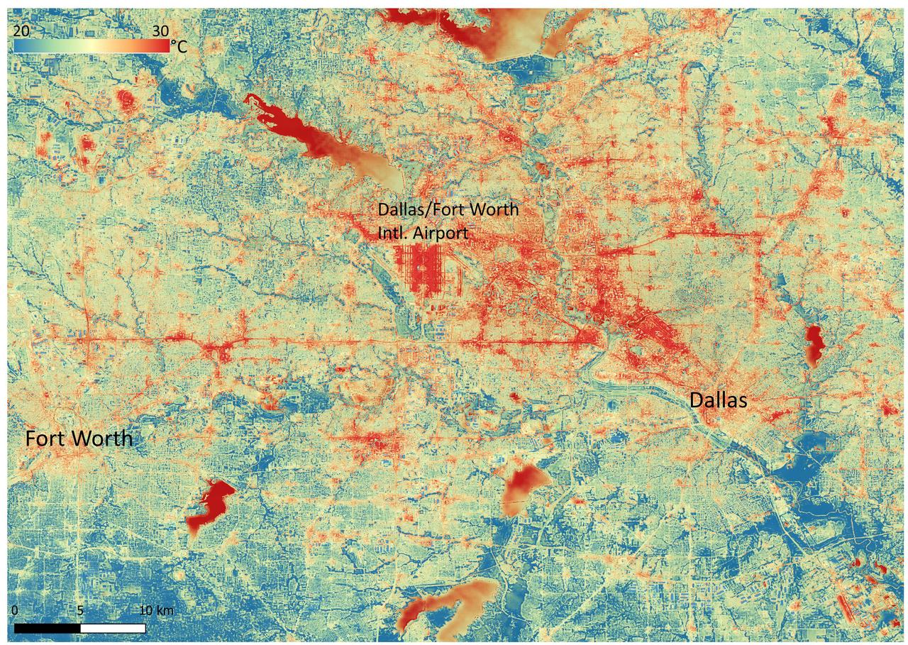 NASA's Ecosystem Spaceborne Thermal Radiometer Experiment on Space Station (ECOSTRESS) instrument recorded this image of ground surface temperatures in Dallas and Fort Worth, Texas, on June 20, 2022, at 7:17 a.m. Central Daylight Time.  Even early in the day, manmade urban surfaces near city centers and transportation networks – streets, roads, and highways shown in red and orange – are warmer than the outskirts by up to 18 degrees Fahrenheit (10 degrees Celsius). The paved surfaces at Dallas/Fort Worth International Airport, shown in red near the top-center of the image, had the warmest temperatures, exceeding 86 F (30 C).  Natural land surfaces such as vegetation and streams in rural areas, shown in green and blue, are cooler than nearby large bodies of water, shown in red and yellow, that tend to retain more heat overnight due to their higher heat capacity.  Cities are usually warmer than open land because of human activities and the materials used in building and construction. Streets are often the hottest part of the built environment due to asphalt paving. Dark-colored surfaces absorb more heat from the Sun than lighter-colored ones; asphalt absorbs up to 95% of solar radiation and retains the heat for hours into the nighttime.  ECOSTRESS measures the temperature of the ground, which is hotter than the air temperature during the daytime. The instrument launched to the space station in 2018. Its primary mission is to identify plants' thresholds for water use and water stress, giving insight into their ability to adapt to a warming climate. However, ECOSTRESS is also useful for documenting other heat-related phenomena, like patterns of heat absorption and retention. Its high-resolution images, with a pixel size of about 225 feet (70 meters) by 125 feet (38 meters), are a powerful tool for understanding our environment.  https://photojournal.jpl.nasa.gov/catalog/PIA25422