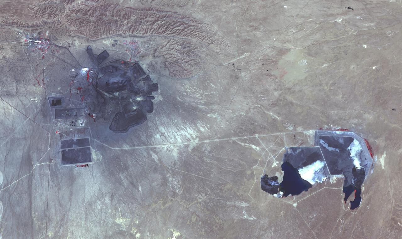 The Muruntau mine in Uzbekistan is the largest gold mine in the world in terms of production. In a single year, Muruntau produces over 2 million ounces of gold. Located in the Qizilqum Desert of Uzbekistan, it is the world's biggest open pit mine. The mine itself is roughly 3.3 km long, 3 km wide and 600 m deep, with its large heap-leach processing plant to the east. Within this huge mine, there is believed to be reserves of over 170 million ounces of gold. The image was acquired July 11, 2021, covers an area of 22.5 by 38.2 km, and is located at 41.5 degrees north, 64.6 degrees east.  https://photojournal.jpl.nasa.gov/catalog/PIA25445