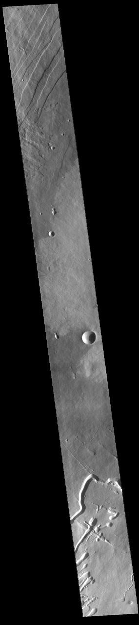 This VIS image shows part of the western flank of Pavonis Mons. Pavonis Mons is the central volcano of the three large Tharsis volcanoes. All three volcanoes form a line located along a tectonic bulge caused by extensional forces in the region. Pavonis Mons is the smallest of the three with a summit of only 14km (46,000 ft). The linear features at the top of the image are concentric faults. The linear and sinuous channel-like features at the bottom of the image likely formed by collapse of the roof of lava tubes into the empty space beneath. Pavonis means peacock in Latin, making the name peacock mountain.  Orbit Number: 89637 Latitude: 0.453403 Longitude: 246.269 Instrument: VIS Captured: 2022-02-28 00:23  https://photojournal.jpl.nasa.gov/catalog/PIA25454