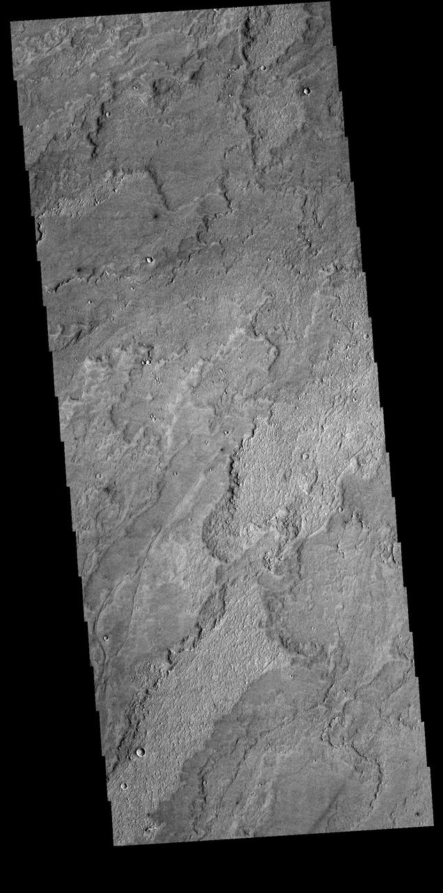 Today's VIS image shows a small portion of the immense lava flows that originated from Arsia Mons. Arsia Mons is the southernmost of the three large aligned volcanoes in the Tharsis region. Arsia Mons' last eruption was 10s of million years ago. The different surface textures are created by differences in the lava viscosity and cooling rates. The lobate margins of each flow can be traced back to the start of each flow — or to the point where they are covered by younger flows. Flows in Daedalia Planum can be as long as 180 km (111 miles). For comparison the longest Hawaiian lava flow is only 51 km (˜31 miles) long. The total area of Daedalia Planum is 2.9 million square km – more than four times the size of Texas. Orbit Number: 89650 Latitude: -23.8918 Longitude: 234.54 Instrument: VIS Captured: 2022-03-01 01:57 https://photojournal.jpl.nasa.gov/catalog/PIA25456