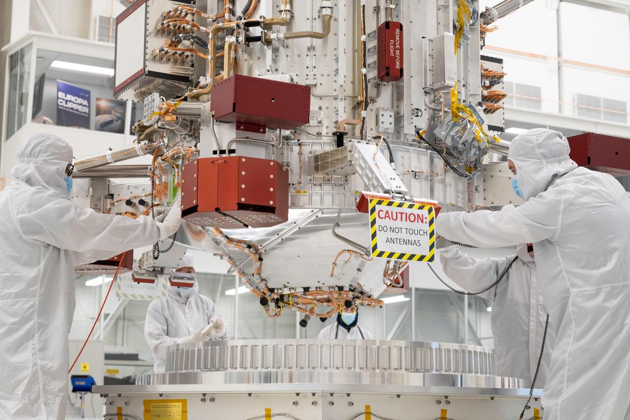 Engineers and technicians use a crane to lower the main body of NASA's Europa Clipper spacecraft into position in the High Bay 1 clean room of the Spacecraft Assembly Facility at the agency's Jet Propulsion Laboratory in Southern California. Standing 10 feet (3 meters) high and 5 feet (1.5 meters) wide, the core will be the focus of attention as the spacecraft is assembled for its launch to Jupiter's moon Europa in October 2024.This image was taken on Aug. 9, 2022.  Europa Clipper will conduct nearly 50 flybys of the icy Jovian moon Europa, which scientists are confident harbors an internal ocean containing twice as much water as Earth's oceans combined. The moon may currently have conditions suitable for supporting life. The spacecraft's nine science instruments, plus a gravity science investigation, will gather data on the moon's atmosphere, surface, and interior – information that scientists will use to gauge the depth and salinity of the ocean, the thickness of the ice crust, and potential plumes that may be venting subsurface water into space.  https://photojournal.jpl.nasa.gov/catalog/PIA25492