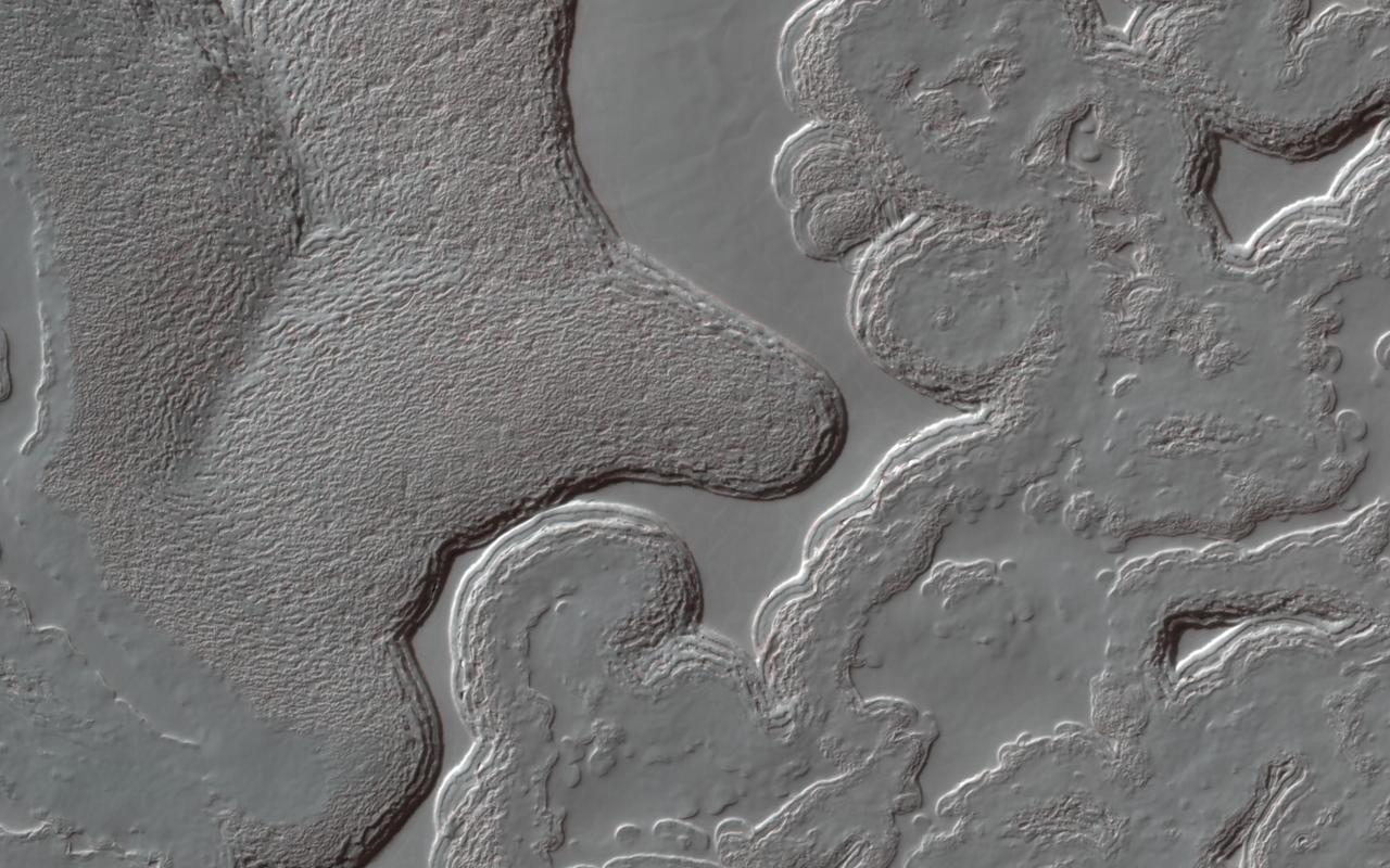 Mars has a small South Polar cap of carbon dioxide ice. Although this cap persists year round, it is always changing: it has pits and mesas that in some places resemble a slice of Swiss cheese. The pits are expanding because the carbon dioxide is sublimating, but in other places new carbon dioxide deposits are building up on flat ground. HiRISE monitors many areas of the cap to study these changes. Usually when we study changes, we can align the images with features that haven’t changed, but here that is difficult: nearly everything is different! By lining up the pattern of shallow pits on top of a mesa, which are not changing much, we can see the variations in the eight Mars years between observations (PSP_004992_0945 and this one). Some of the walls have retreated by more than 15 meters (about 50 feet). https://photojournal.jpl.nasa.gov/catalog/PIA25553