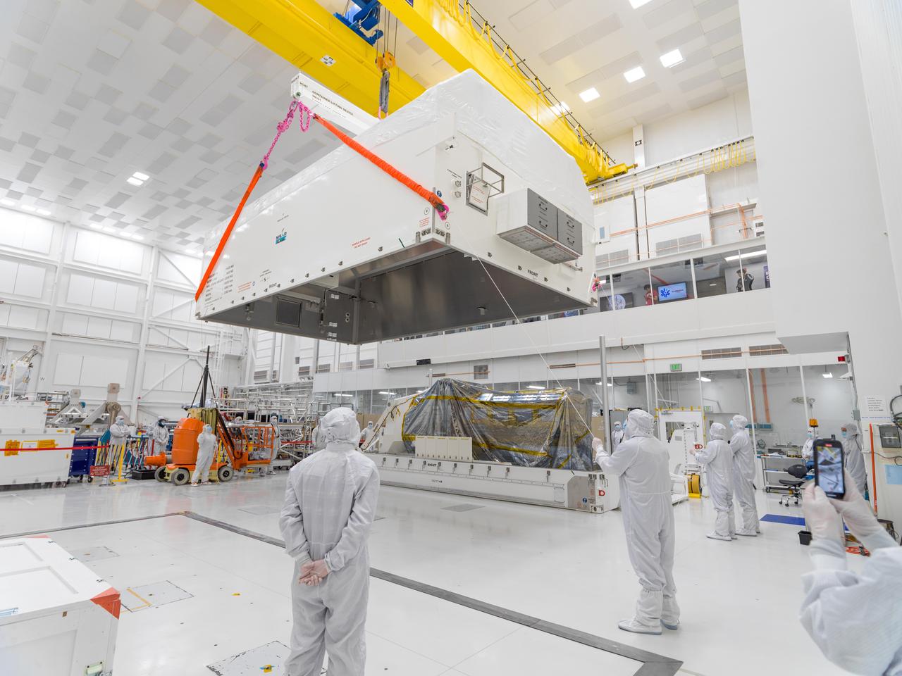       In a clean room at NASA's Jet Propulsion Laboratory on Feb. 23, 2023, engineers and technicians use a crane to prepare to seal a specially designed, climate-controlled shipping container holding the NASA-ISRO Synthetic Aperture Radar (NISAR) science instrument payload. The payload was then shipped to Bengaluru, India, on March 3, arriving on March 6. There it will be integrated with the satellite body, or bus, and undergo further testing leading up to launch in 2024.      The NISAR mission – a joint effort between NASA and the Indian Space Research Organisation – will observe nearly all the planet's land and ice surfaces twice every 12 days, measuring movements in extremely fine detail. It will also survey forests and agricultural regions to understand carbon exchange between plants and the atmosphere. NISAR's science payload will be the most advanced radar system ever launched as part of a NASA mission, and it will feature the largest-ever radar antenna of its kind: a drum-shaped, wire mesh reflector nearly 40 feet (12 meters) in diameter that will extend from a 30-foot (9-meter) boom.      The mission's science instruments consist of L- and S-band radar, so named to indicate the wavelengths of their signals. ISRO built the S-band radar, which it shipped to JPL in March 2021. Engineers spent much of the last two years integrating the instrument with the JPL-built L-band system, then conducting tests to verify they work well together.      JPL, which is managed for NASA by Caltech in Pasadena, leads the U.S. component of NISAR. In addition to the L-band radar, NASA is also providing the radar reflector antenna, the deployable boom, a high-rate communication subsystem for science data, GPS receivers, a solid-state recorder, and payload data subsystem. In addition to the S-band radar, ISRO is providing the spacecraft bus, the launch vehicle, and associated launch services and satellite mission operations.  https://photojournal.jpl.nasa.gov/catalog/PIA25567