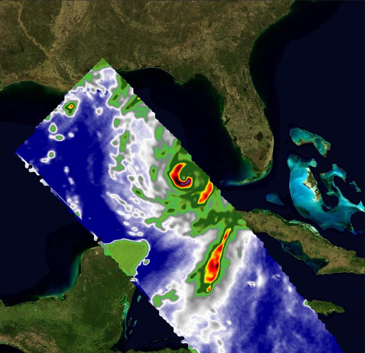 A pair of weather instruments built at NASA's Jet Propulsion Laboratory in Southern California captured images of Hurricane Idalia as the storm approached the Gulf Coast of Florida on Aug. 29, 2023. COWVR (short for Compact Ocean Wind Vector Radiometer) and TEMPEST (Temporal Experiment for Storms and Tropical Systems) observe the planet's atmosphere and surface from aboard the International Space Station, which passed in low Earth orbit over this area at about 11:34 a.m. EDT. Idalia was forecast to make landfall in Florida on Aug. 30. This image combines microwave emissions measurements from both COWVR and TEMPEST. White sections indicate the presence of clouds. Green portions indicate rain. Yellow, red, and black indicate where air and water vapor were moving most vigorously. Idalia's center is seen about 200 miles (322 kilometers) west of the Florida Keys, and rainfall is indicated on the western end of Cuba. https://photojournal.jpl.nasa.gov/catalog/PIA25569