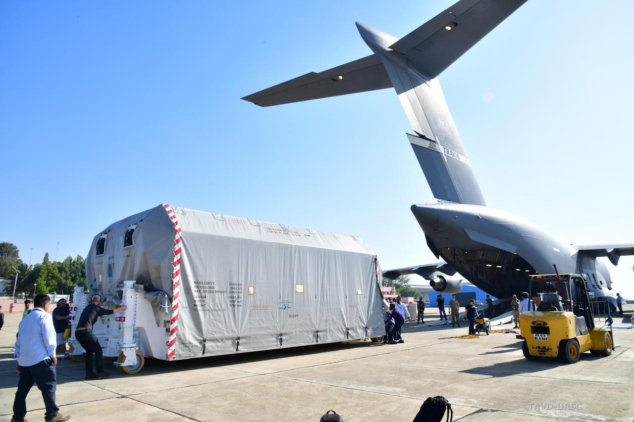 The NASA-ISRO Synthetic Aperture Radar (NISAR) science instrument payload, housed in a specially designed shipping container, sits at Hindustan Aeronautics Limited Airport in Bengaluru, India. The payload left NASA's Jet Propulsion Laboratory in Southern California on Feb. 28, and departed the United States on March 3 aboard a U.S. Air Force cargo plane, arriving in Bengaluru on March 6. From there it was transported to the Indian Space Research Organisation's U R Rao Satellite Centre, where it will be integrated with the satellite body, or bus, and undergo further testing leading up to launch in 2024. The NISAR mission – a joint effort between NASA and the Indian Space Research Organisation – will observe nearly all the planet's land and ice surfaces twice every 12 days, measuring movements in extremely fine detail. It will also survey forests and agricultural regions to understand carbon exchange between plants and the atmosphere. NISAR's science payload will be the most advanced radar system ever launched as part of a NASA mission, and it will feature the largest-ever radar antenna of its kind: a drum-shaped, wire mesh reflector nearly 40 feet (12 meters) in diameter that will extend from a 30-foot (9-meter) boom. The mission's science instruments consist of L- and S-band radar, so named to indicate the wavelengths of their signals. ISRO built the S-band radar, which it shipped to JPL in March 2021. Engineers spent much of the last two years integrating the instrument with the JPL-built L-band system, then conducting tests to verify they work well together. JPL, which is managed for NASA by Caltech in Pasadena, leads the U.S. component of NISAR. In addition to the L-band radar, NASA is also providing the radar reflector antenna, the deployable boom, a high-rate communication subsystem for science data, GPS receivers, a solid-state recorder, and payload data subsystem. In addition to the S-band radar, ISRO is providing the spacecraft bus, the launch vehicle, and associated launch services and satellite mission operations. https://photojournal.jpl.nasa.gov/catalog/PIA25570